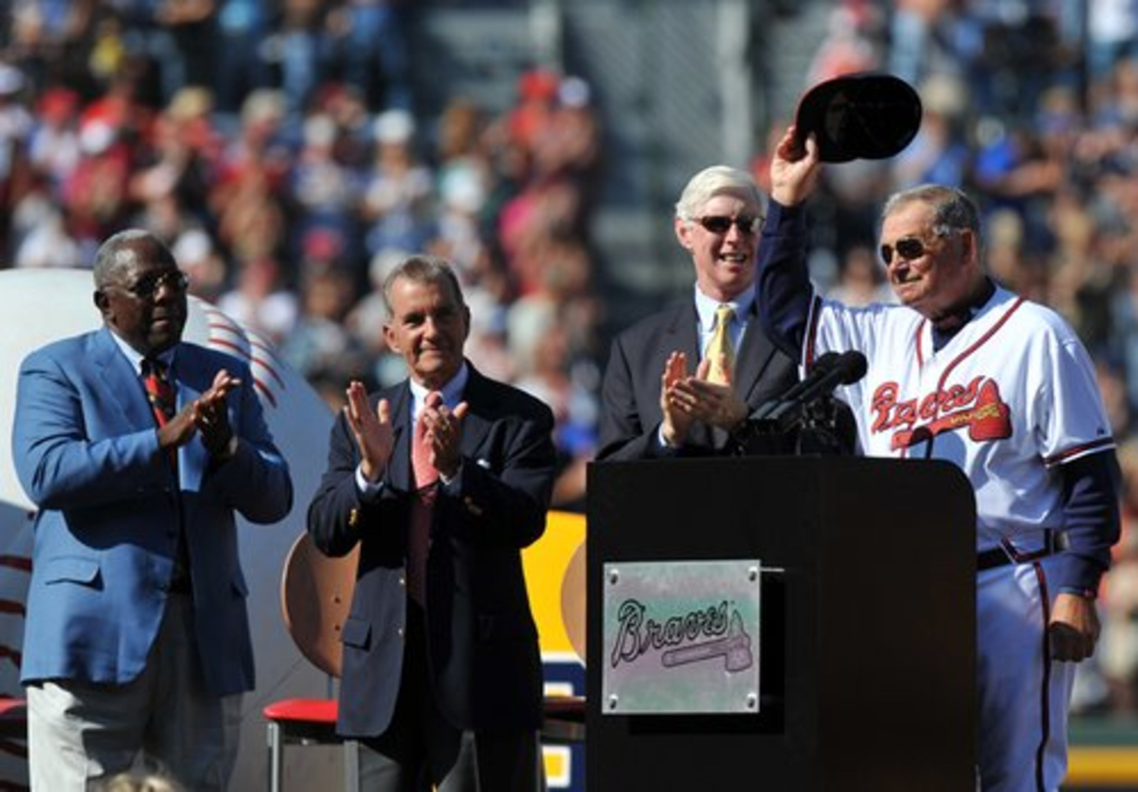 With Hank Aaron (from left) John Schuerholz and Terry McGurik giving praise, Braves' retiring manager Bobby Cox salutes the crowd during ceremony. Saturday, Oct. 2, 2010. Photos by Brant Sanderlin.