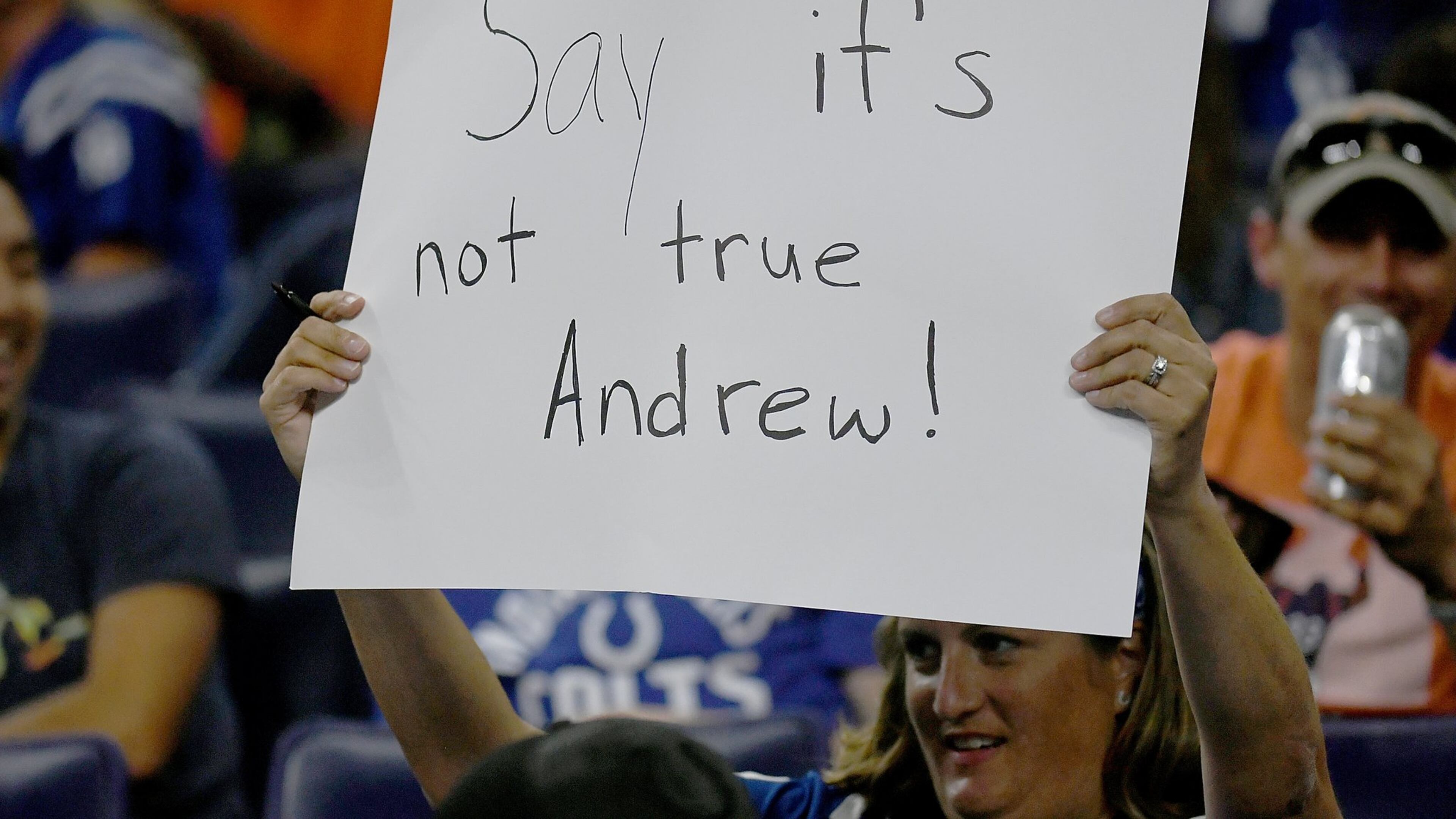 An Indianapolis Colts fan holds up a sign after sports reporter Adam Schefter tweeted that quarterback Andrew Luck was planning on retiring during the fourth quarter of the game between the Chicago Bears and the Indianapolis Colts at Lucas Oil Stadium on Aug. 24, 2019, in Indianapolis. BOBBY ELLIS / GETTY IMAGES