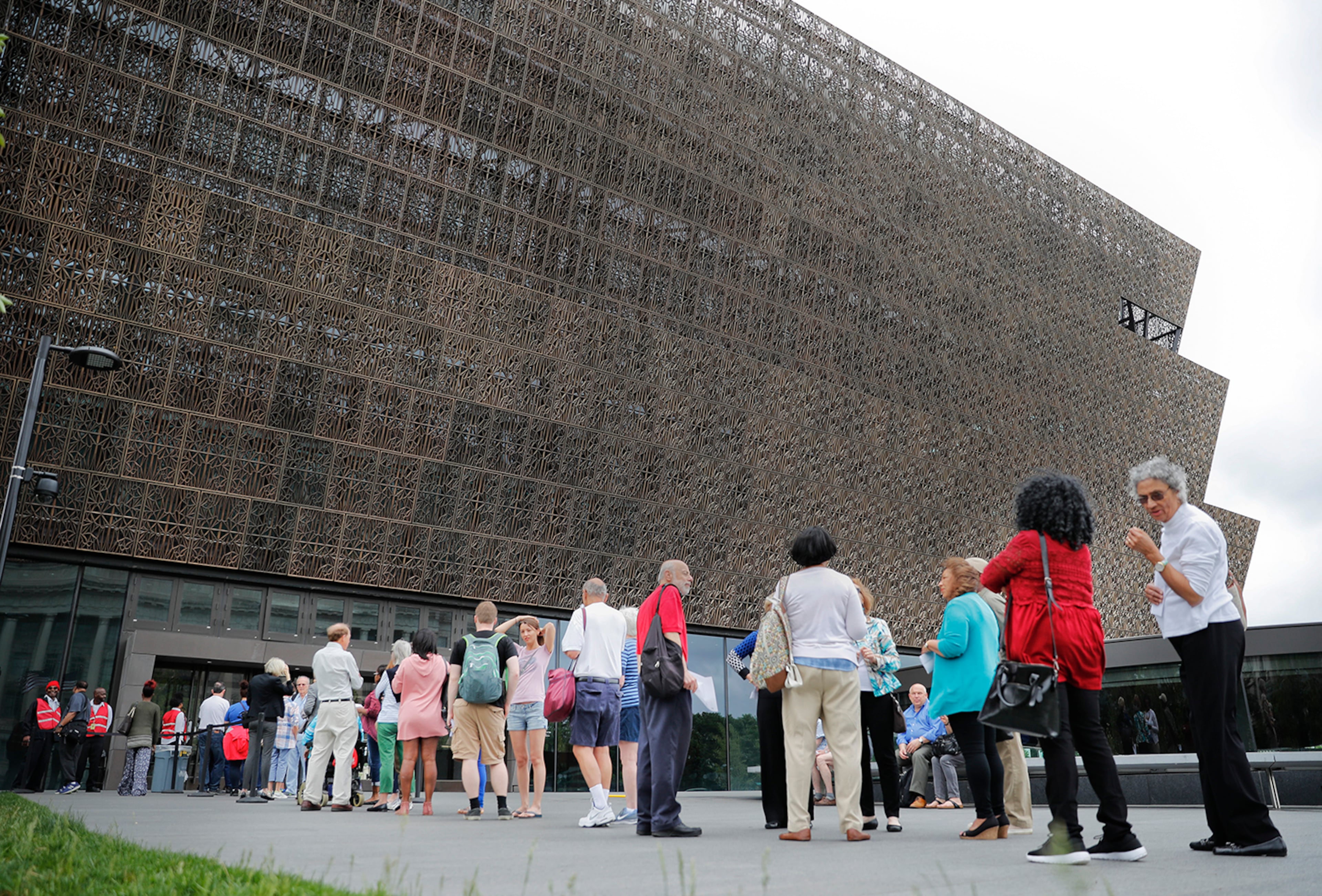 Lucille Simpson, far right, and her daughter Gwendolyn Norman, both from Detroit, Mich., wait in line to enter the Smithsonian National Museum of African American History and Cultural on the National Mall in Washington, Monday, May 1, 2017. The hottest ticket in Washington right now is for the new museum, where thousands of tickets are snapped up each month within minutes of being released, a full seven months after the museum opened. (AP Photo/Pablo Martinez Monsivais)