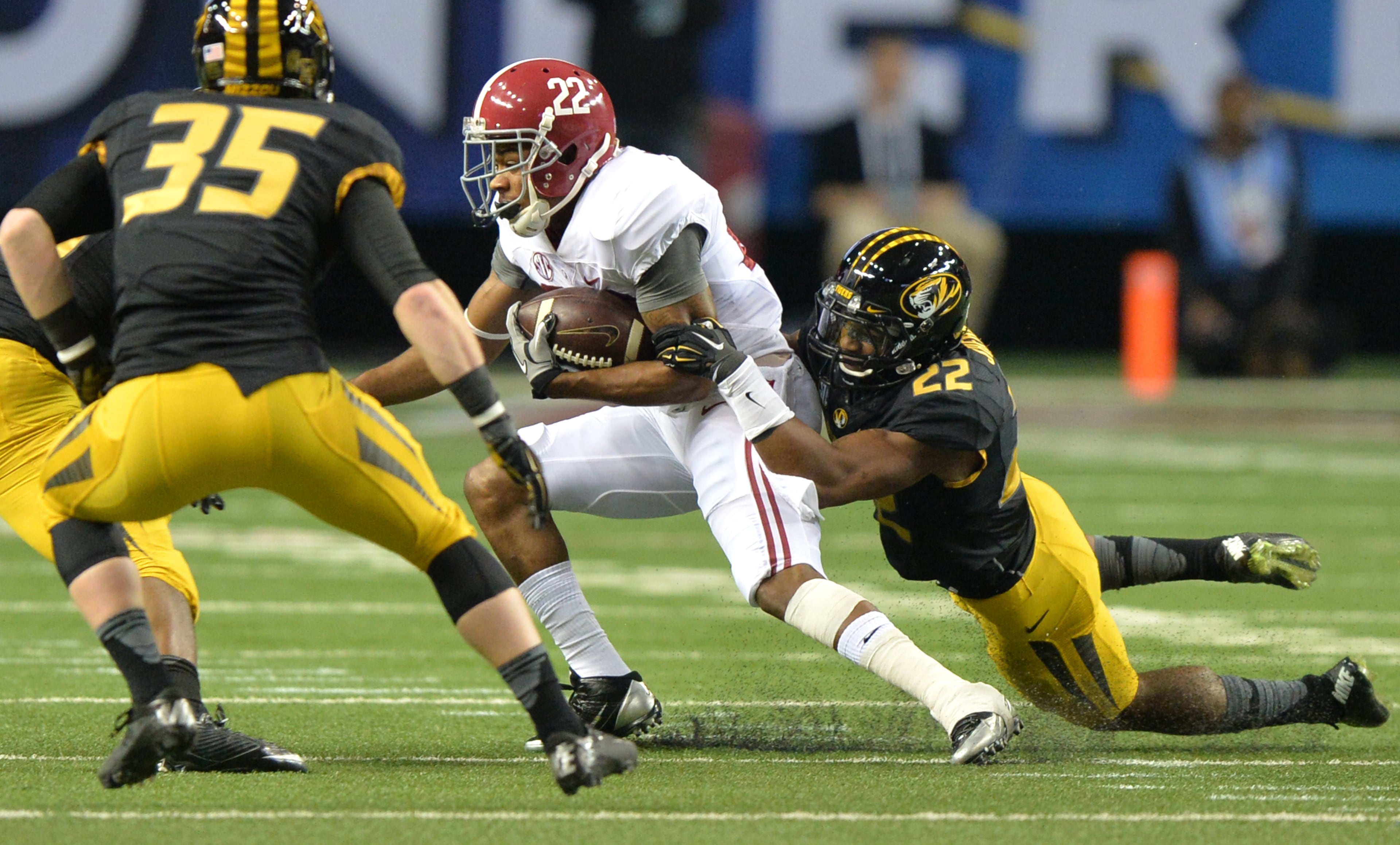 Alabama Crimson Tide wide receiver Christion Jones is hit by Missouri Tigers defensive back Anthony Sherrils during the first half of the 2014 SEC Championship at the Georgia Dome Saturday December 6, 2014. BRANT SANDERLIN / BSANDERLIN@AJC.COM