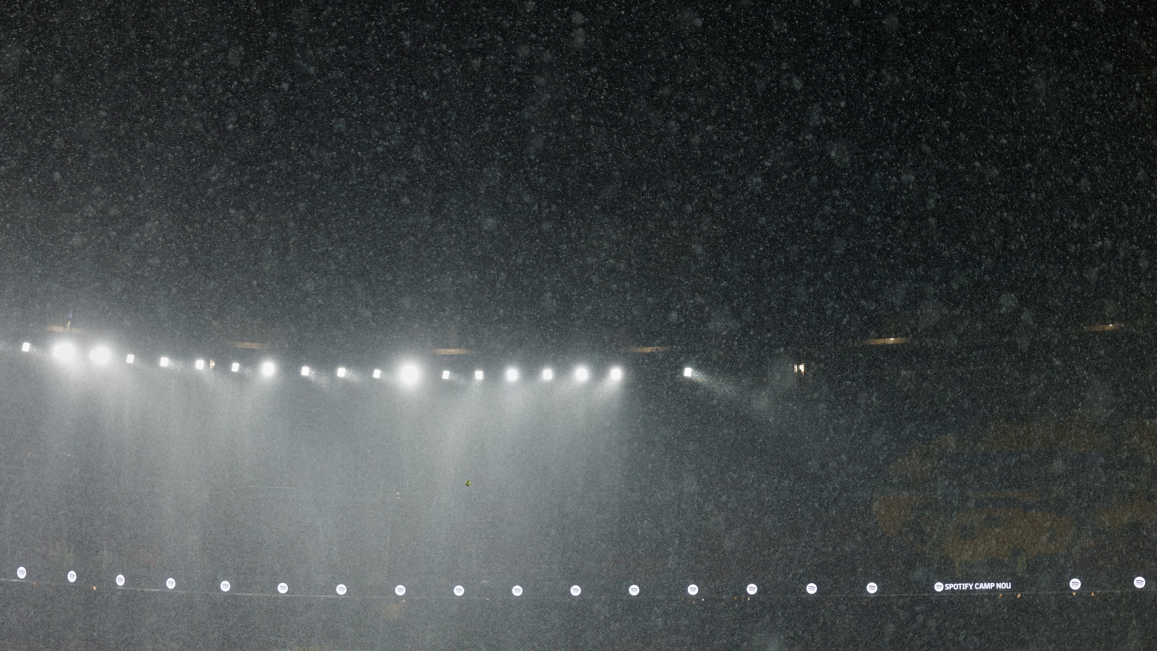 A heavy rain falls on the field during a Spanish La Liga soccer match between Barcelona and Real Oviedo in Barcelona, Spain, Sunday, Jan. 25, 2026. (AP Photo/Joan Monfort)