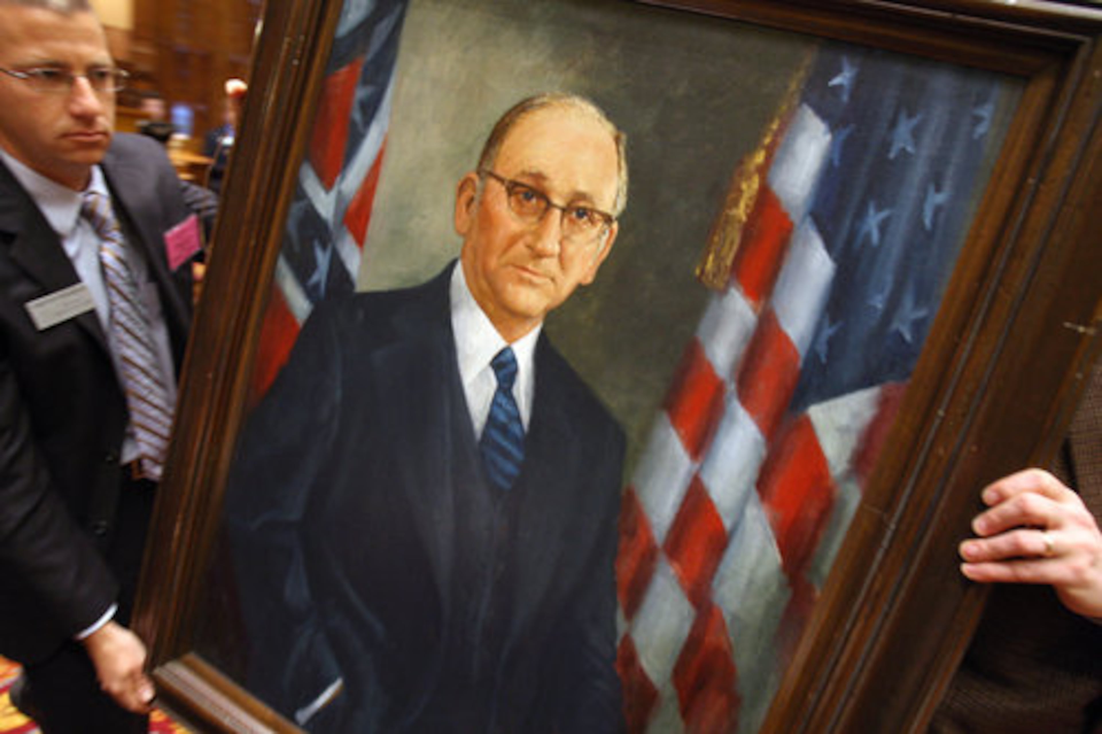 Timothy Frilingos of Georgia Capitol Museum prepares to place a portrait of late Speaker Tom Murphy outside the chamber on Wednesday. Murphy, the nation's longest serving speaker of the House, died in December 2007. (AJC)