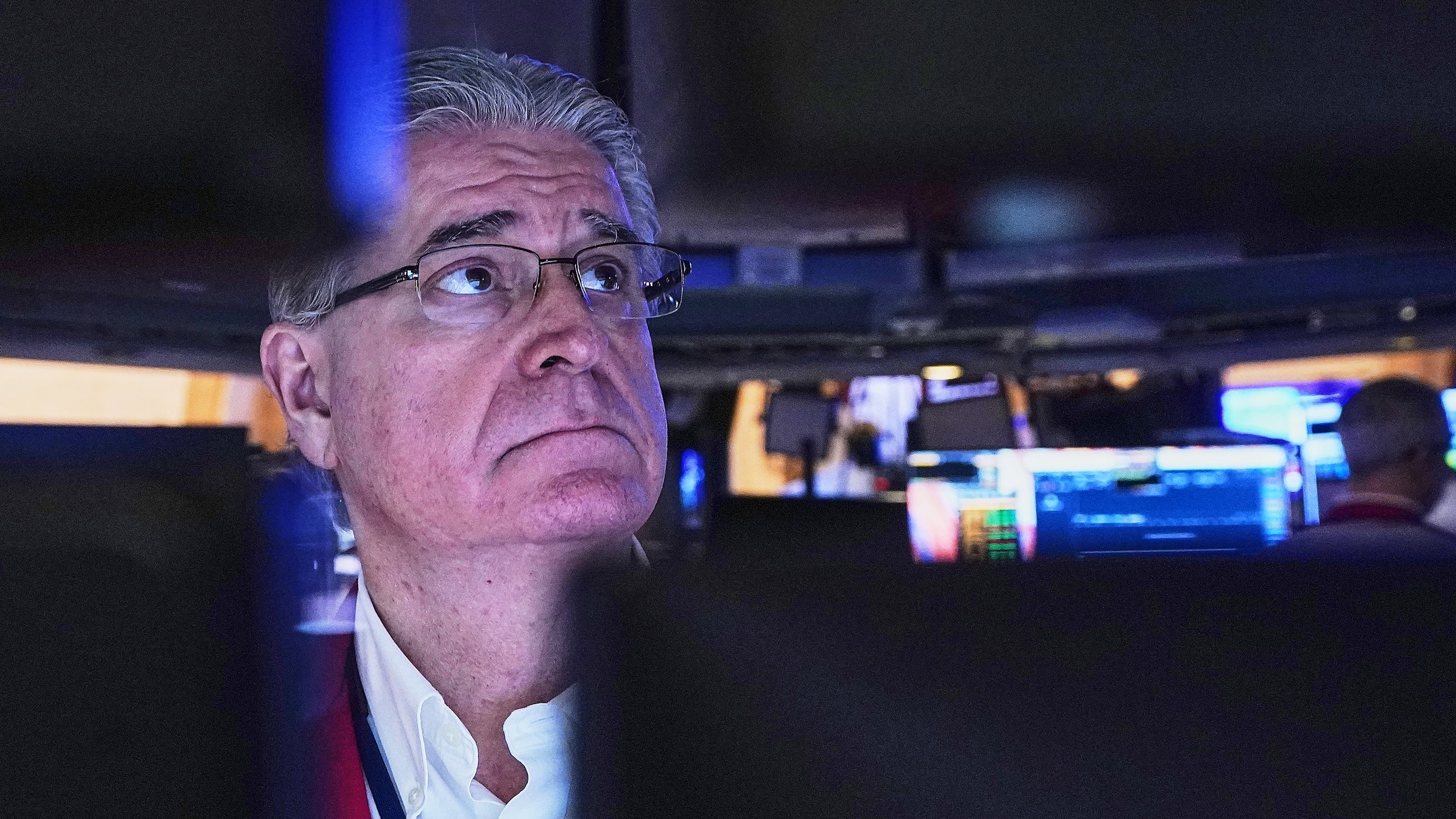 Trader Daniel Krieger is framed by his computer monitors as he works on the floor of the New York Stock Exchange, Wednesday, Jan. 21, 2026. (AP Photo/Richard Drew)