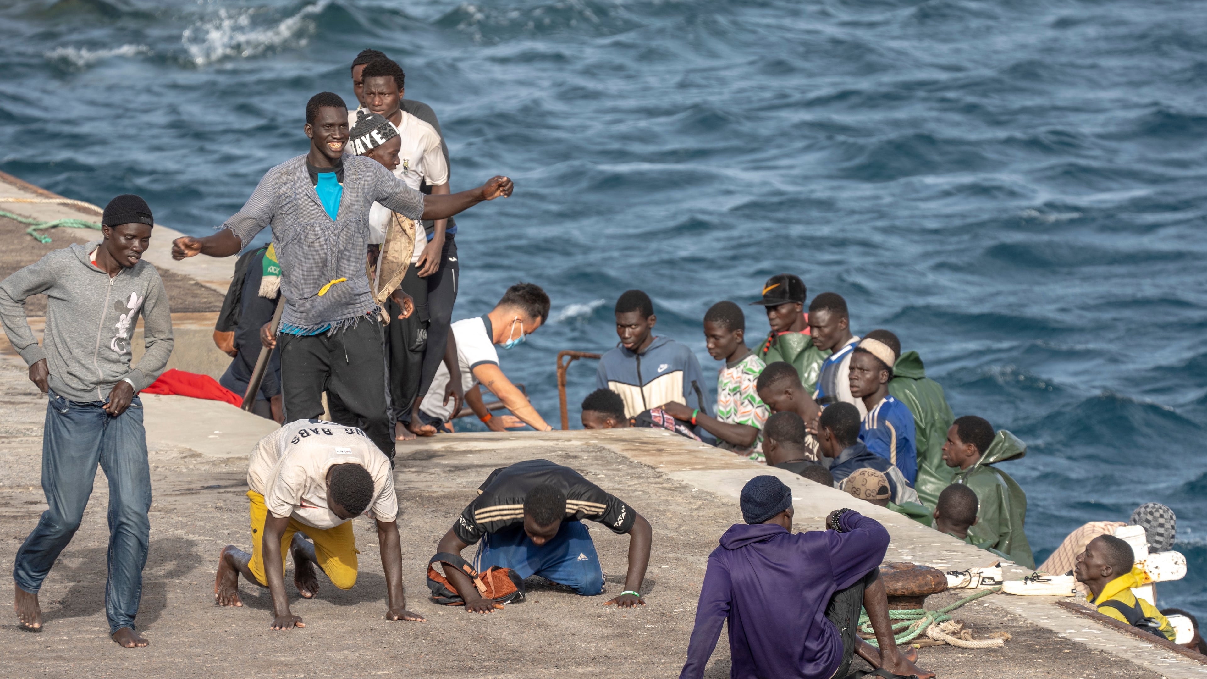 FILE - Migrants react as they arrive at the port in La Restinga on the Canary island of El Hierro, Spain, on, Aug. 19, 2024. (AP Photo/Maria Ximena, File)