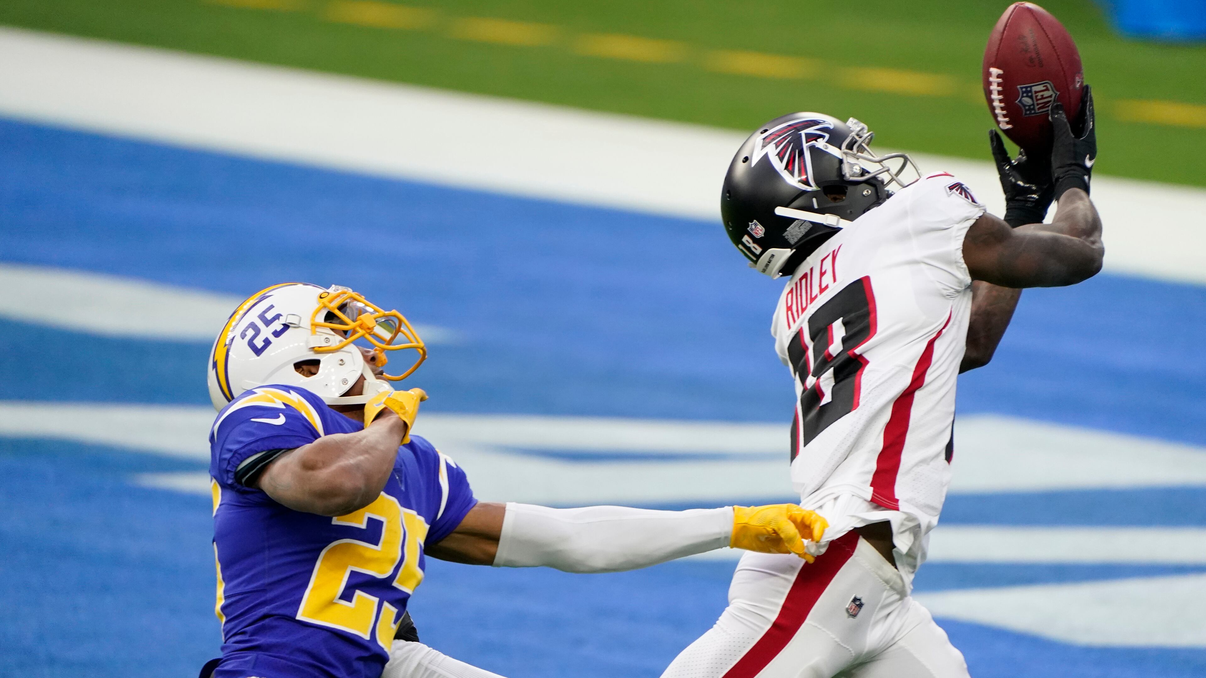 Atlanta Falcons wide receiver Calvin Ridley (right) catches a touchdown pass from wide receiver Russell Gage in front of Los Angeles Chargers cornerback Chris Harris Jr. during the first half Sunday, Dec. 13, 2020, in Inglewood, Calif. (Jae C. Hong/AP)