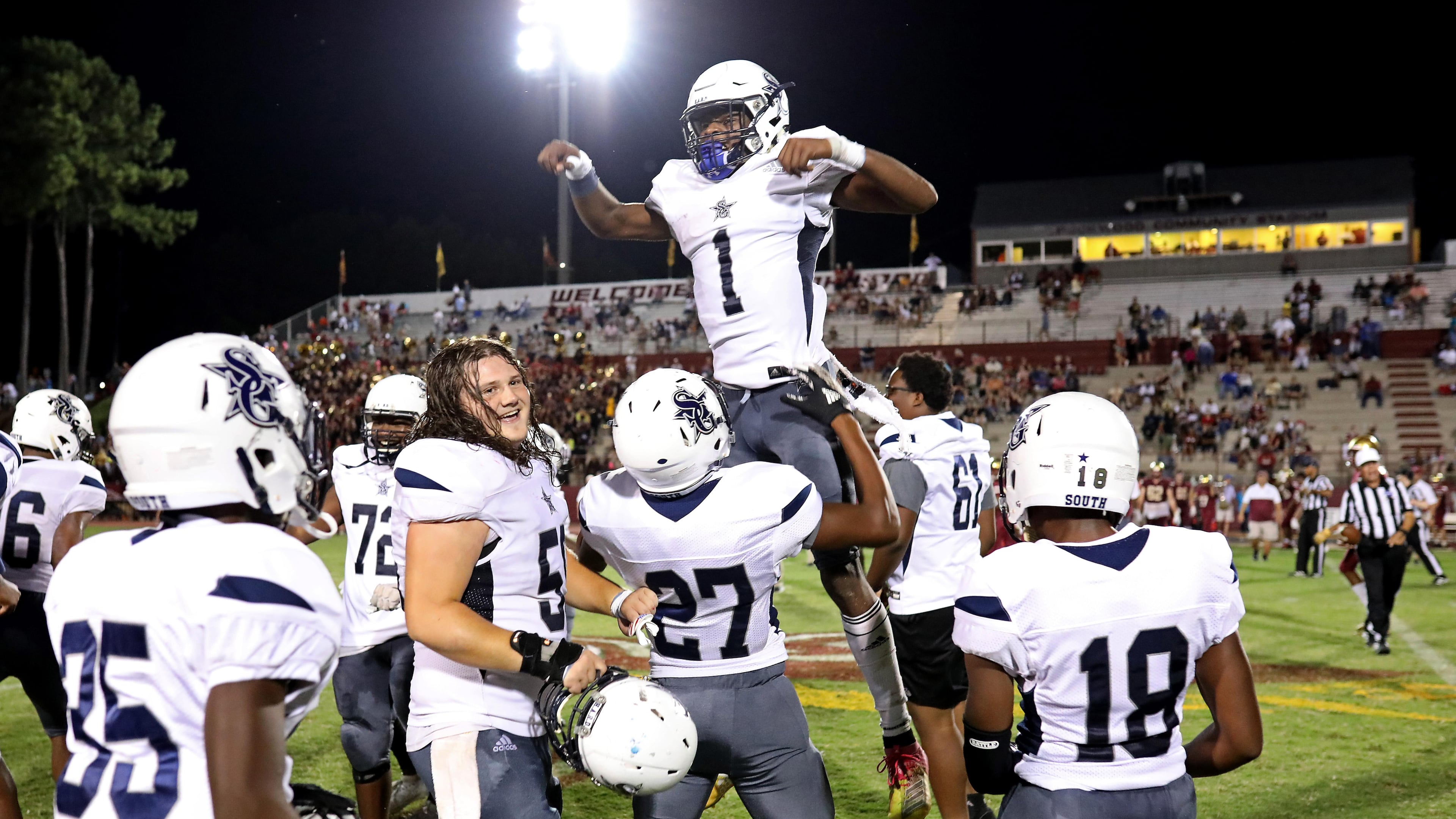 September 6, 2019 - Snellville, Ga: South Gwinnett quarterback Tre Truitt (1) celebrates with Caleb Pedro (27) after they defeated Brookwood 35-21 at Brookwood High School Friday, September 6, 2019 in Snellville, Ga.. (JASON GETZ/SPECIAL TO THE AJC)