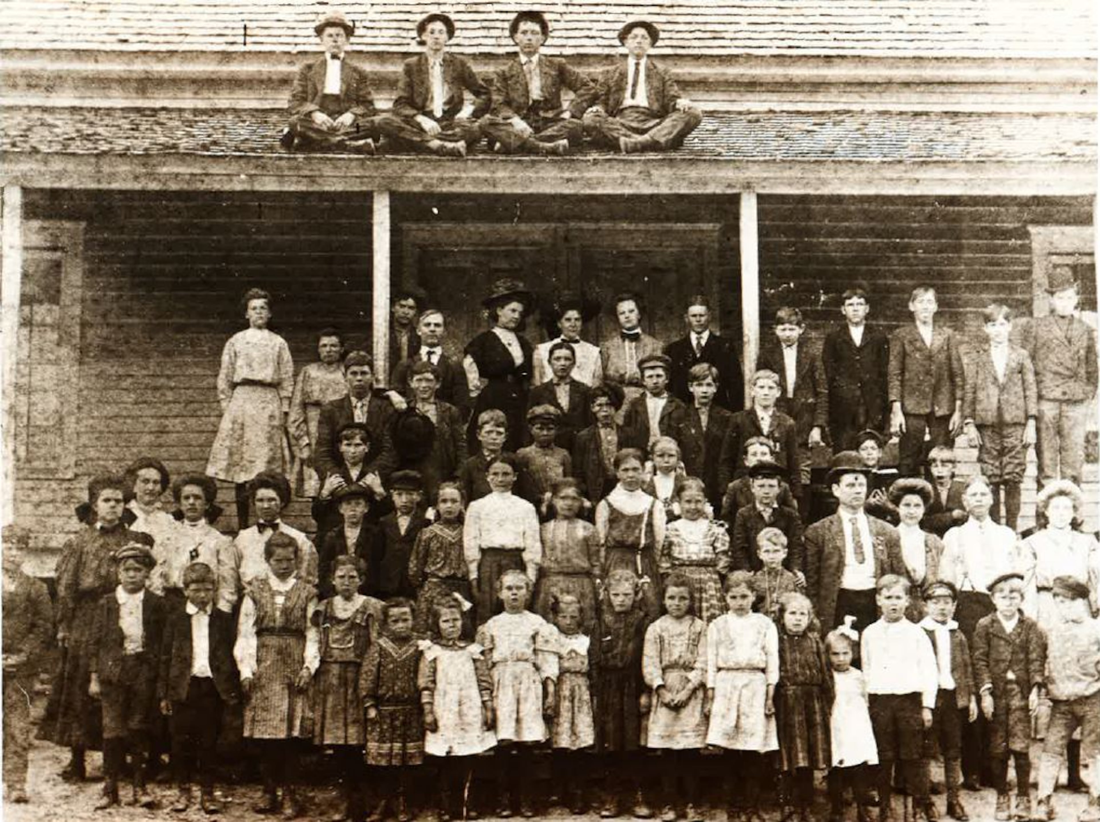Students at the Glenn School, located on Rockbridge Road between U.S. 78 and Centerville, as photographed in 1909. "Teachers Miss Stacy and Miss Mobley must have had a rough time with students as four of them have escaped onto the roof," the Gwinnett Historical Society notes. (Courtesy Gwinnett Historical Society and the Georgia Department of Archives and History)