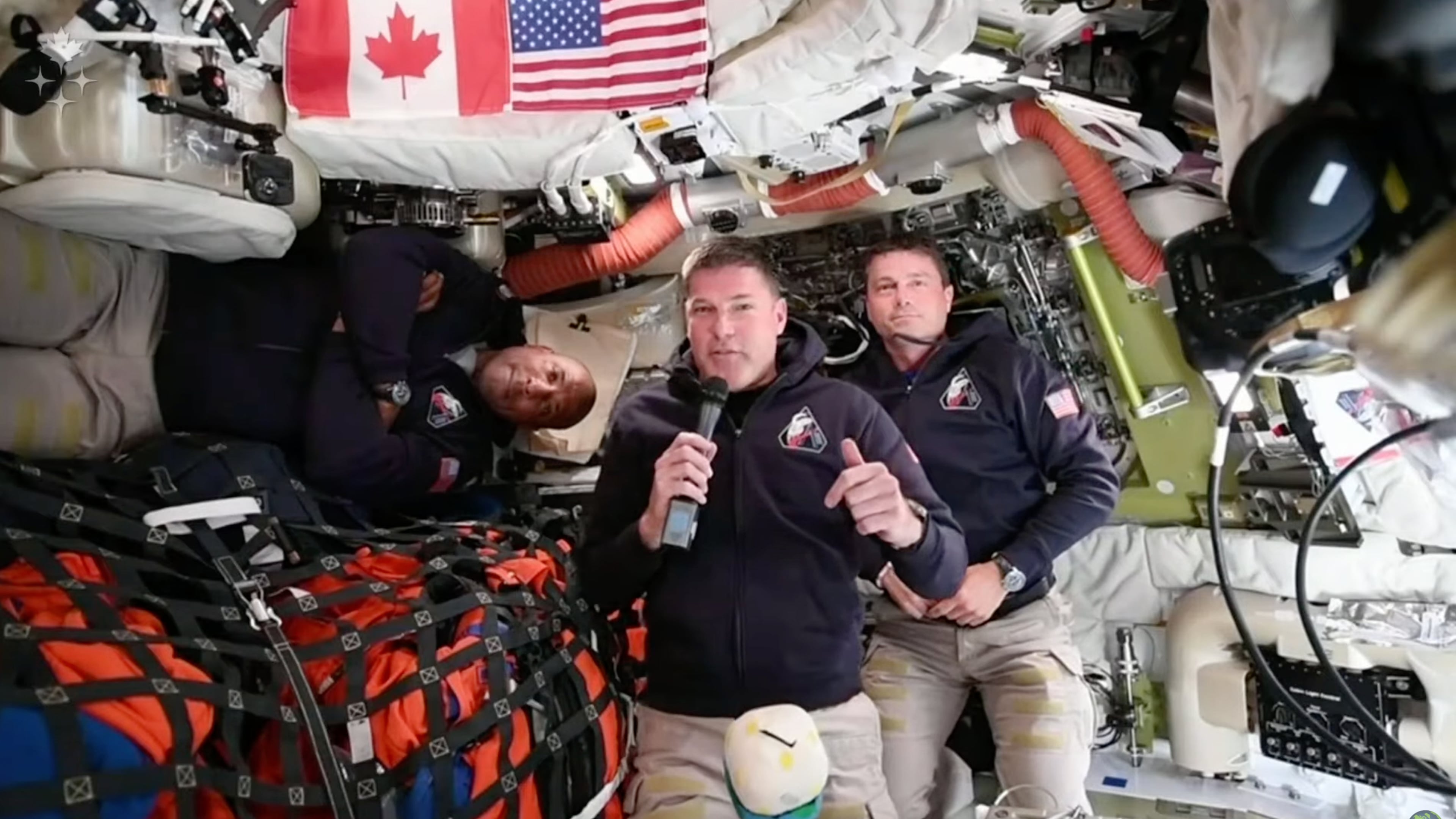 This image provided by the Canadian Space Agency, Artemis II astronaut Jeremy Hansen of Canada, connects live from the Orion spacecraft and speaks with Canadian media along with astronauts Victor Glover, left, and Reid Wiseman on Saturday, April 4, 2026. (Canadian Space Agency via AP)
