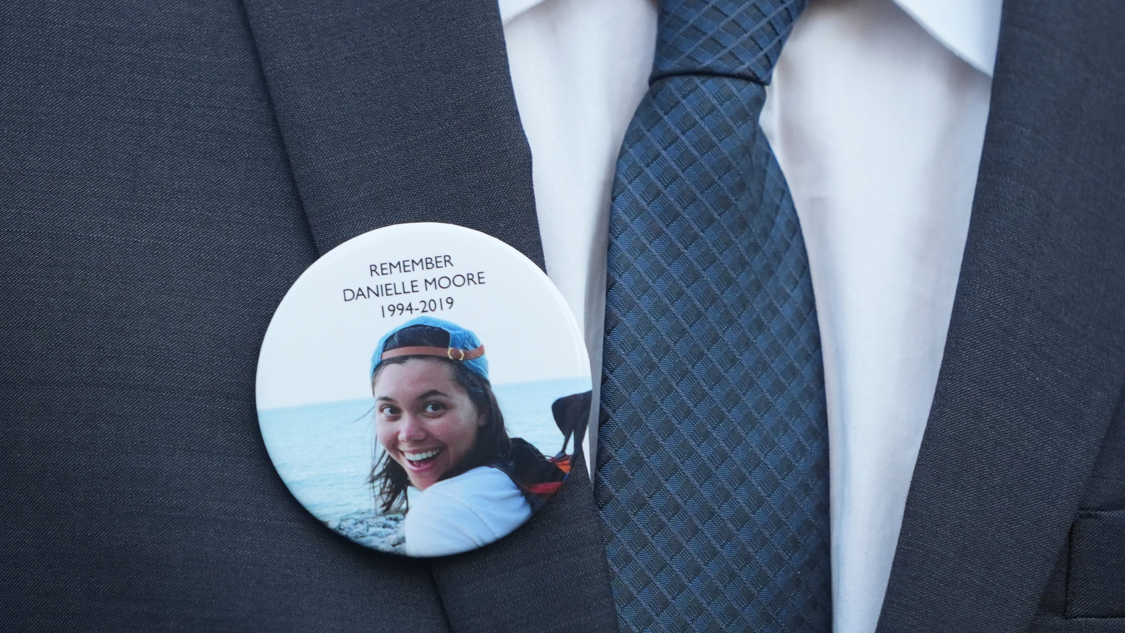 FILE - A family member wears a photo of a Boeing crash victim Danielle Moore before a hearing at federal court in Fort Worth, Texas, Sept. 3, 2025. (AP Photo/LM Otero, File)
