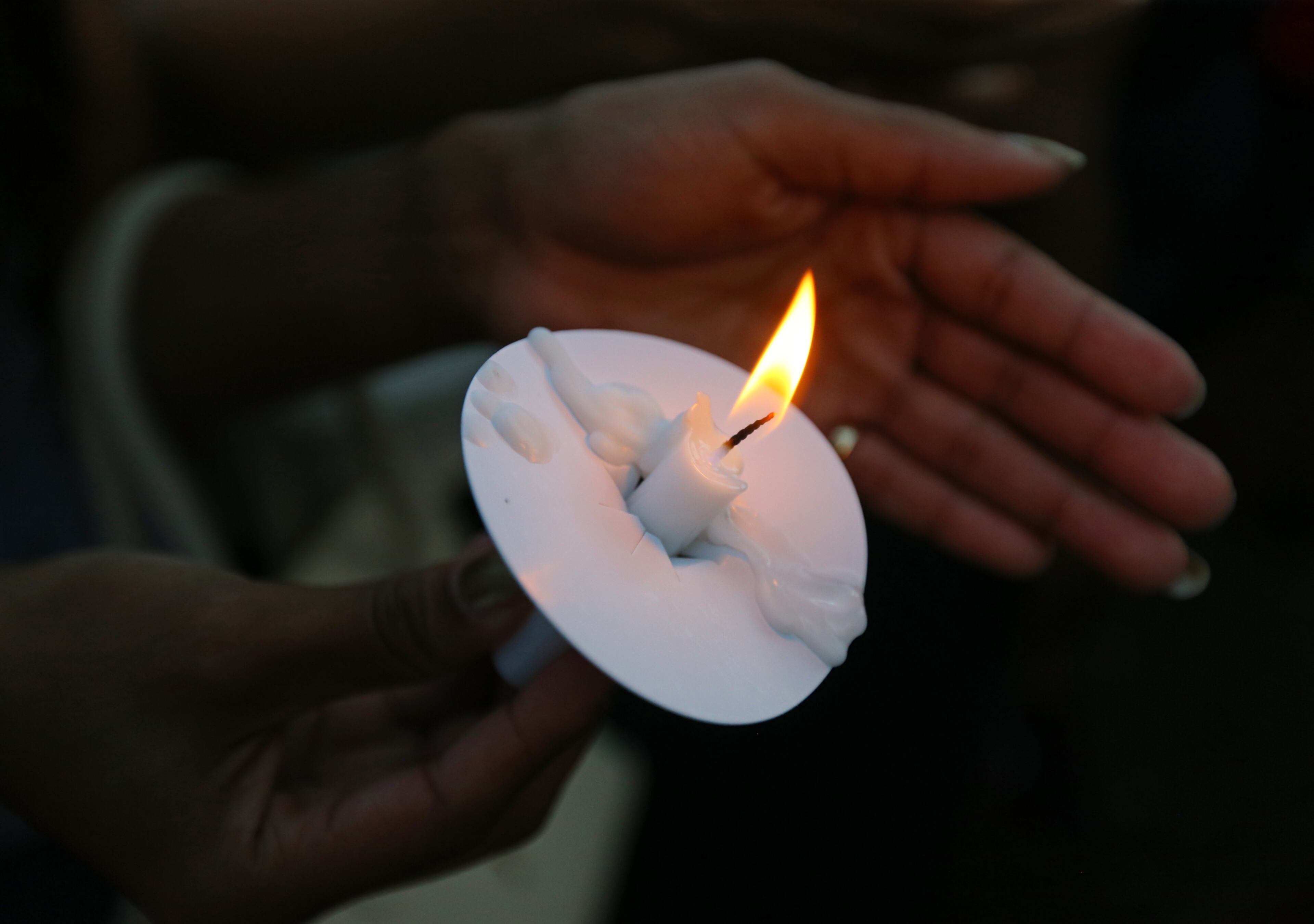 Clark Atlanta University student Saasha Lambert holds a candle during a vigil and moment of silence protesting the police shooting of Michael Brown as part of a national observance on Thursday, Aug. 14, 2014, in Decatur. CURTIS COMPTON / CCOMPTON@AJC.COM