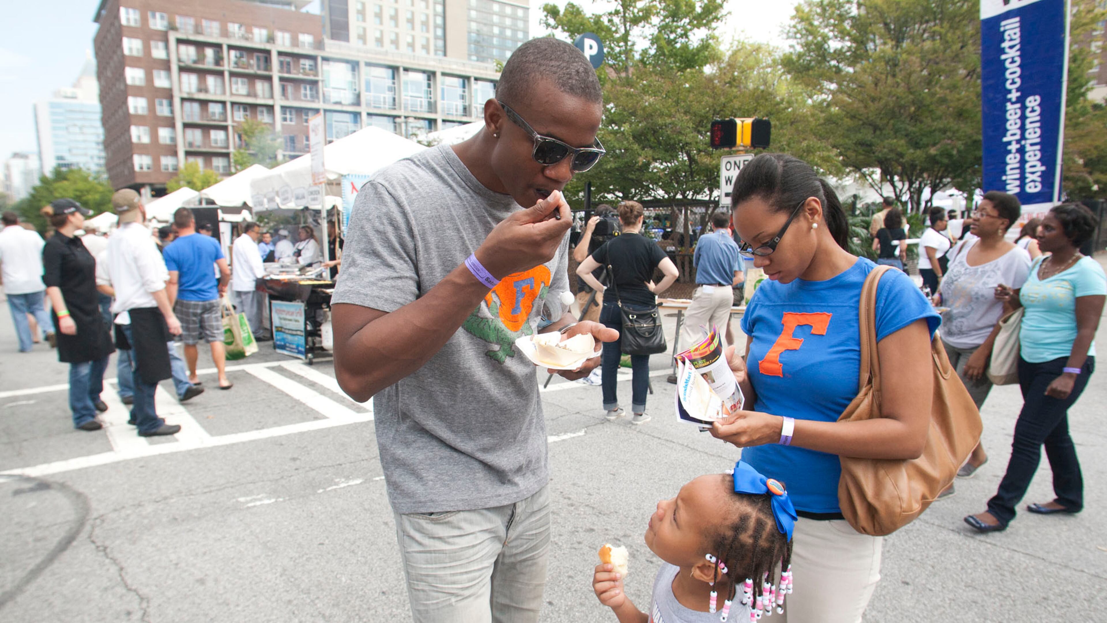 Maurio Andrews enjoys Taste of Atlanta 2012 with his wife Ashley and daughter Ava. (AJC File Photo)