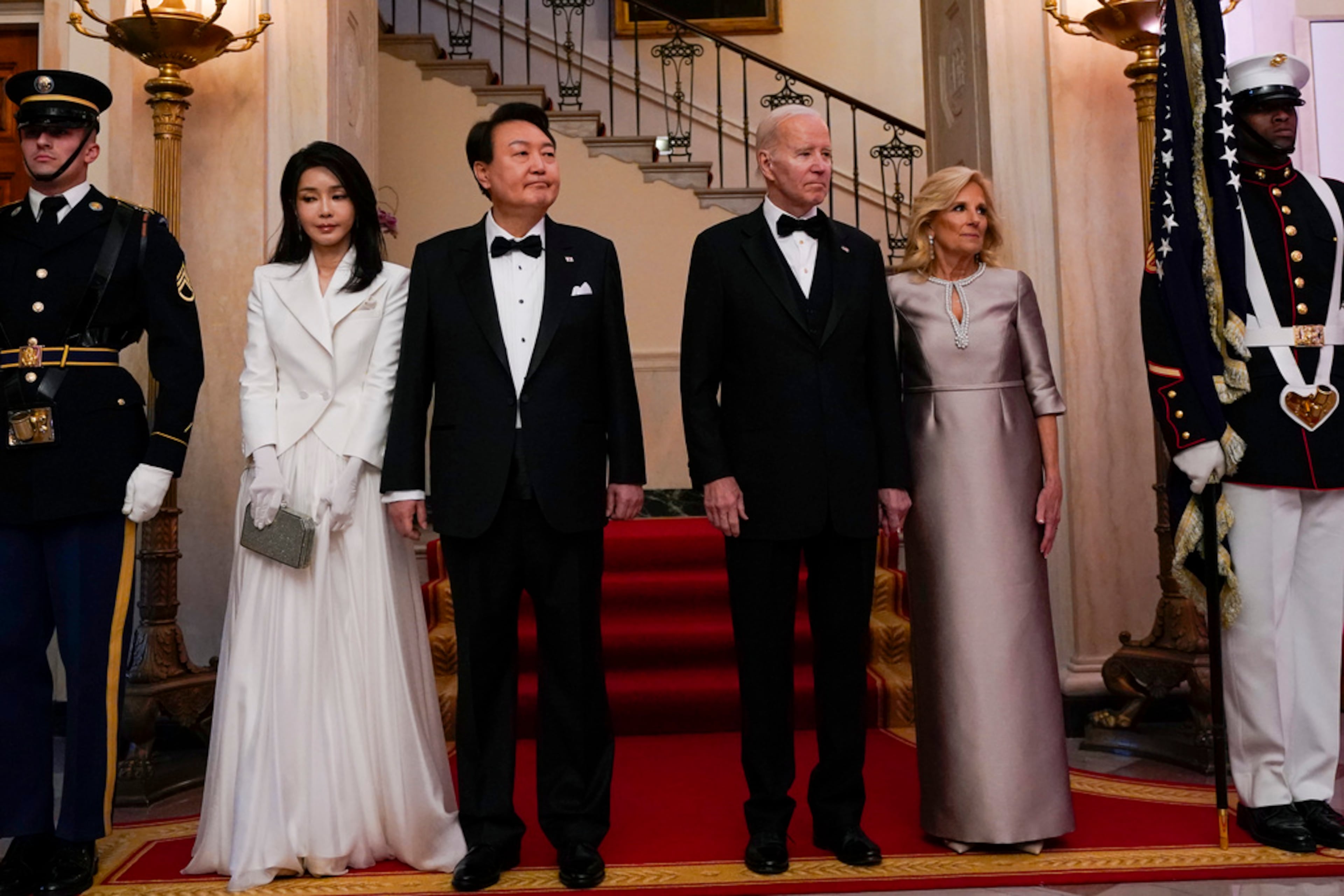 South Korea's President Yoon Suk Yeol and his wife Kim Keon Hee and President Joe Biden and first lady Jill Biden arrive for a photo in front of the Grand Staircase during a State Dinner at the White House in Washington, Wednesday, April 26, 2023. (AP Photo/Susan Walsh)