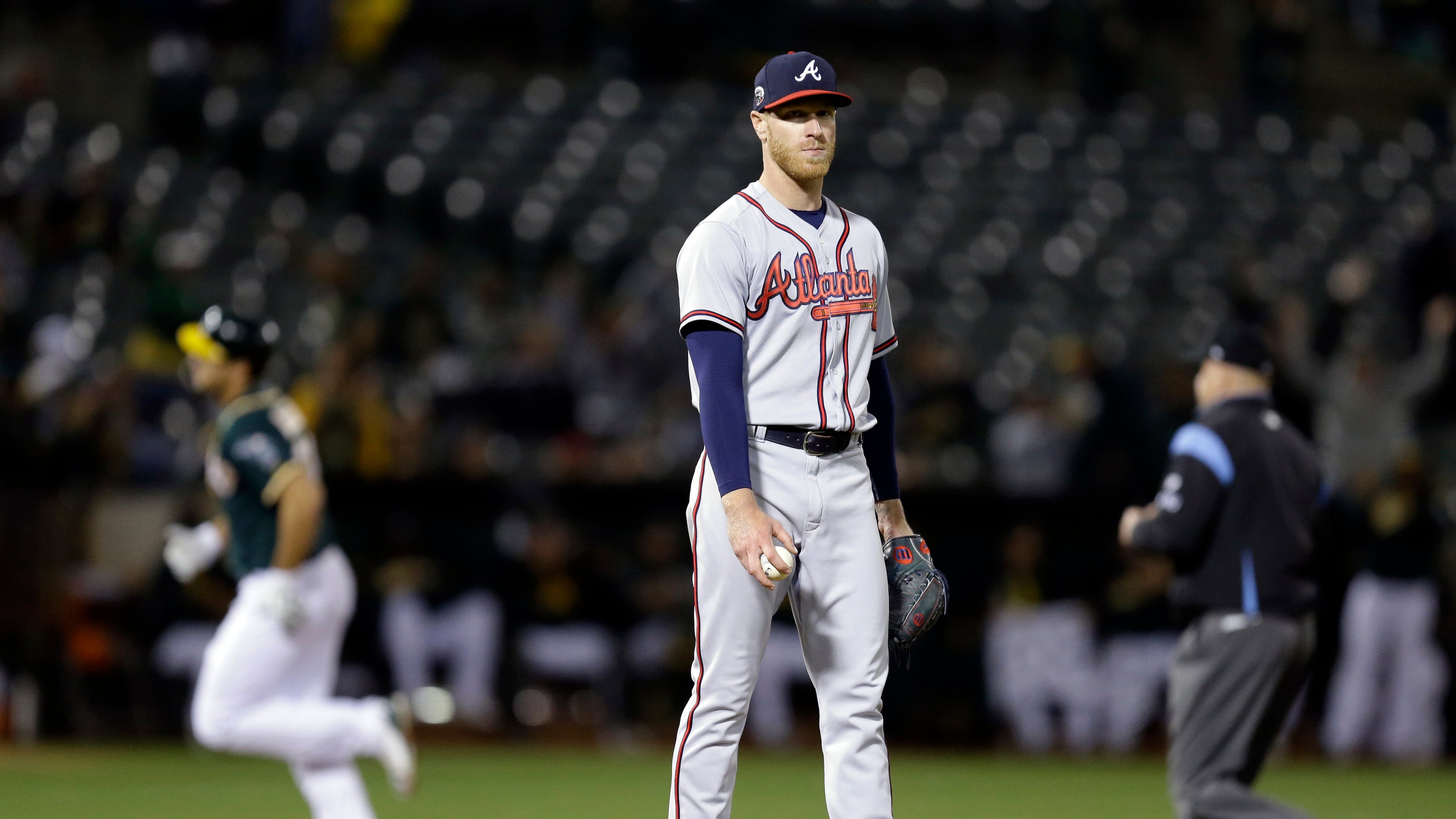 Atlanta Braves pitcher Mike Foltynewicz, center, waits for Oakland Athletics' Matt Olson, left, to run the bases on a home run during the ninth inning of a baseball game Friday, June 30, 2017, in Oakland, Calif. (AP Photo/Ben Margot)