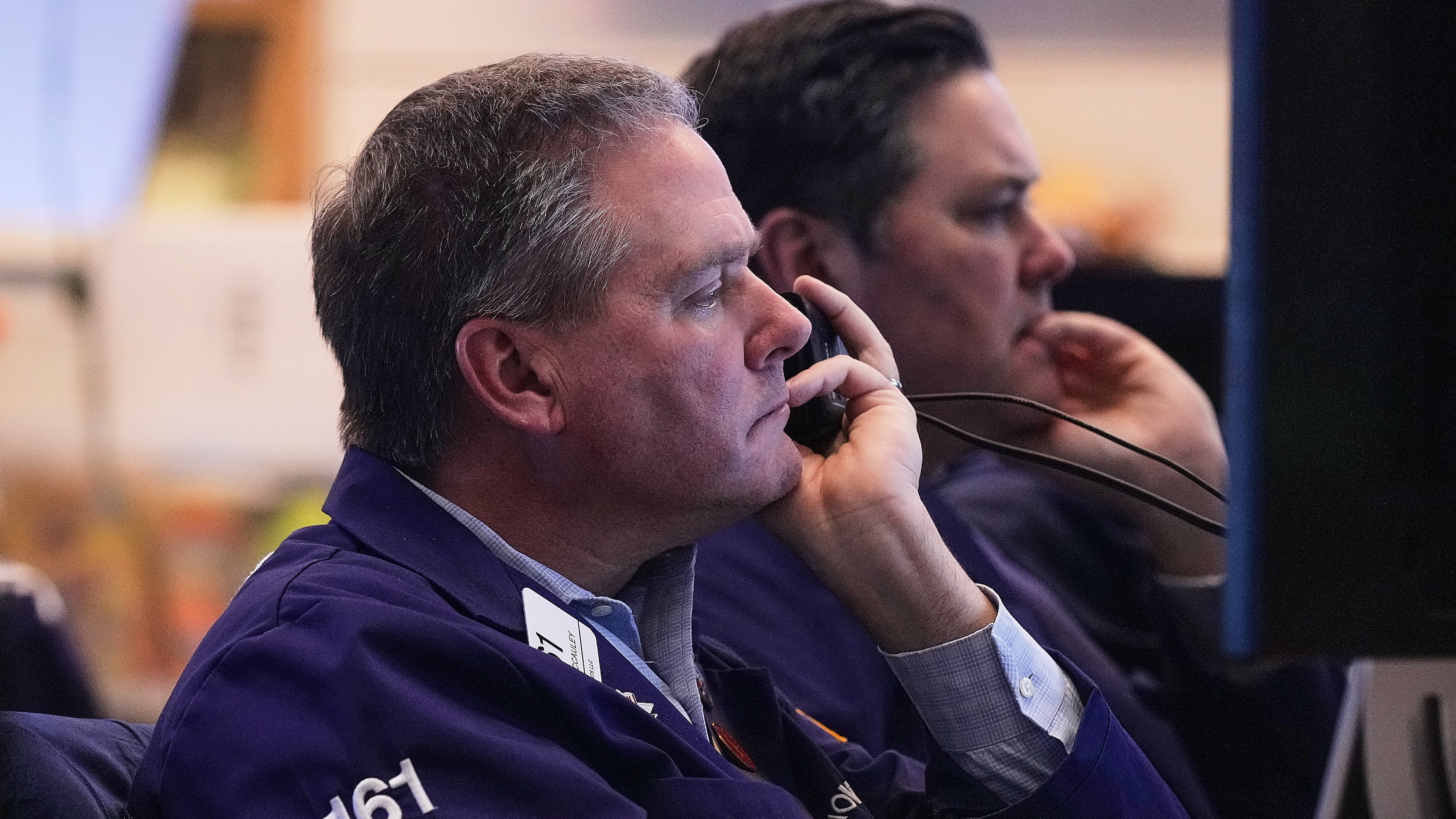 Trader Thomas McCauley, foreground, and a colleague work on the floor of the New York Stock Exchange, Friday, Jan. 2, 2026. (AP Photo/Richard Drew)