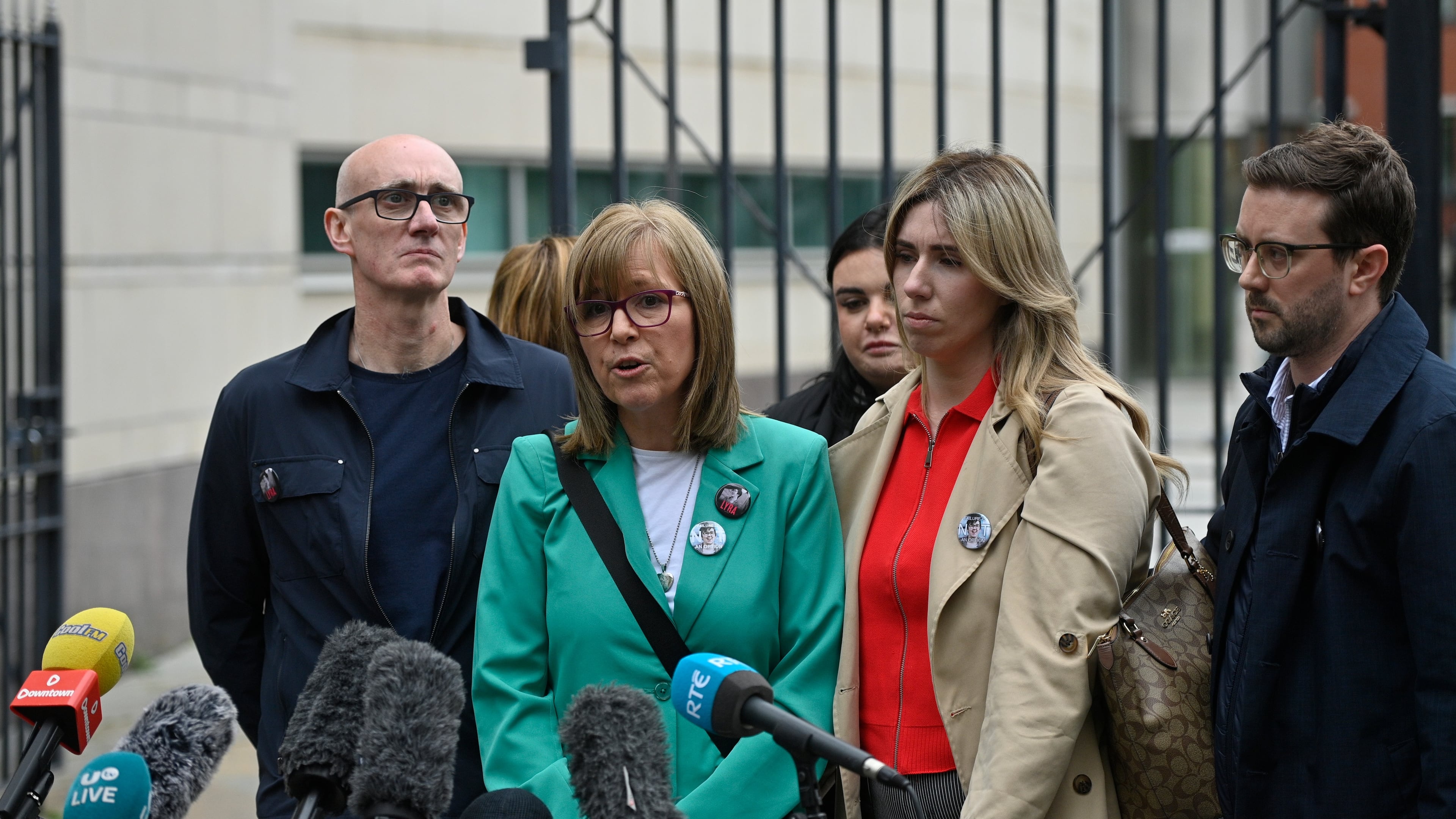 Lyra McKee's sister Nichola Corner, center, speaks to the media outside Belfast Crown Court in Belfast, Ireland, where Paul McIntyre, Peter Cavanagh and Jordan Gareth Devine have been found not guilty in a non-jury trial of the murder of journalist Lyra McKee, Friday July 3, 2026. (PA via AP)