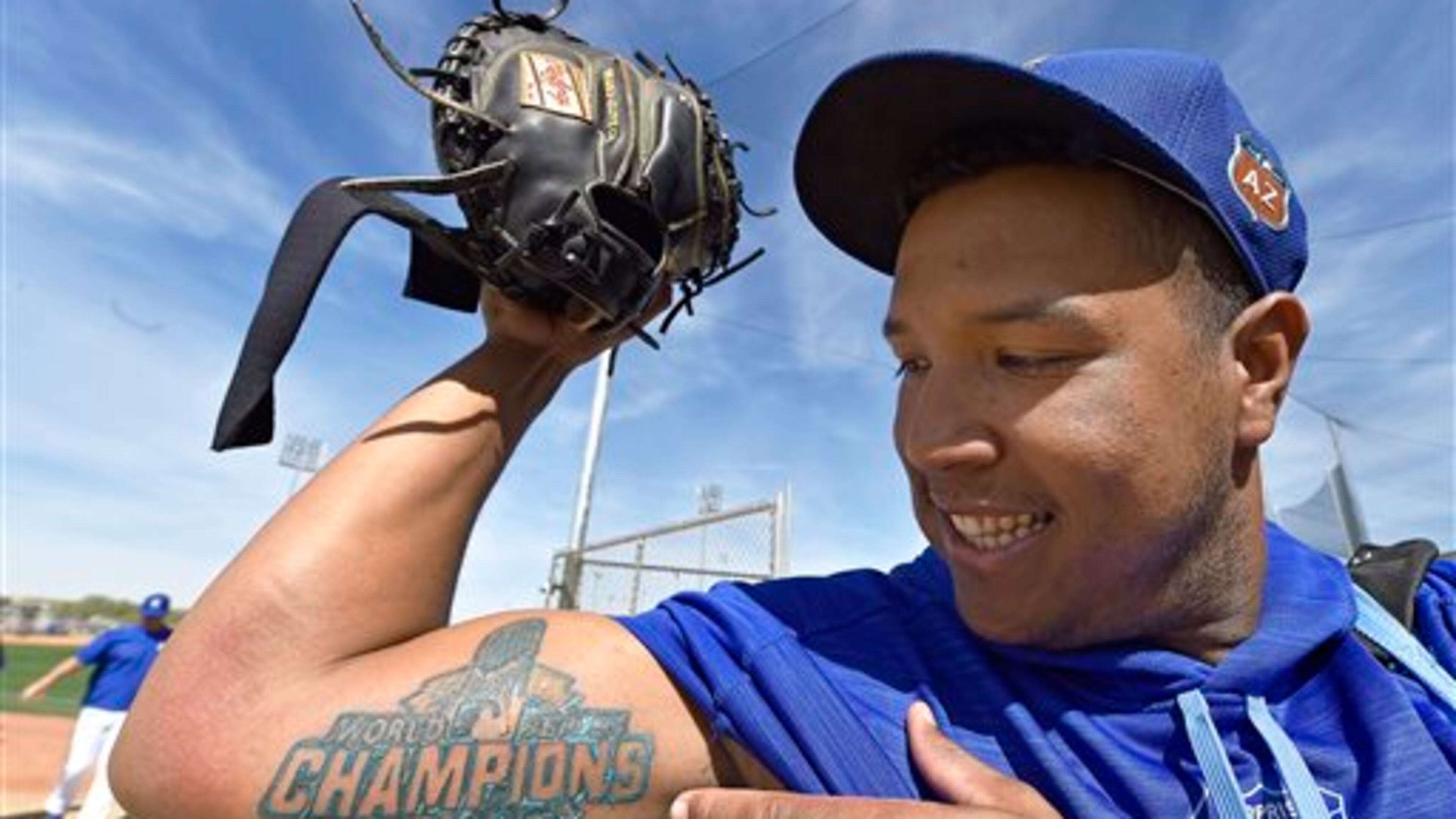 FILE - In this Tuesday, March 1, 2016, file photo, Kansas City Royals' Salvador Perez shows his new World Series Championship tattoo following spring baseball practice in Surprise, Ariz. In a move that Perez�s agent, Rick Thurman, said he had never experienced in all his years in baseball, the Royals gave their three-time Gold Glove winner a $52.5 million, five-year contract that was tacked onto this year, effectively replacing a laughable $7 million, five-year deal from 2012 that included three years of budget-friendly options. (John Sleezer/The Kansas City Star via AP, File) MANDATORY CREDIT