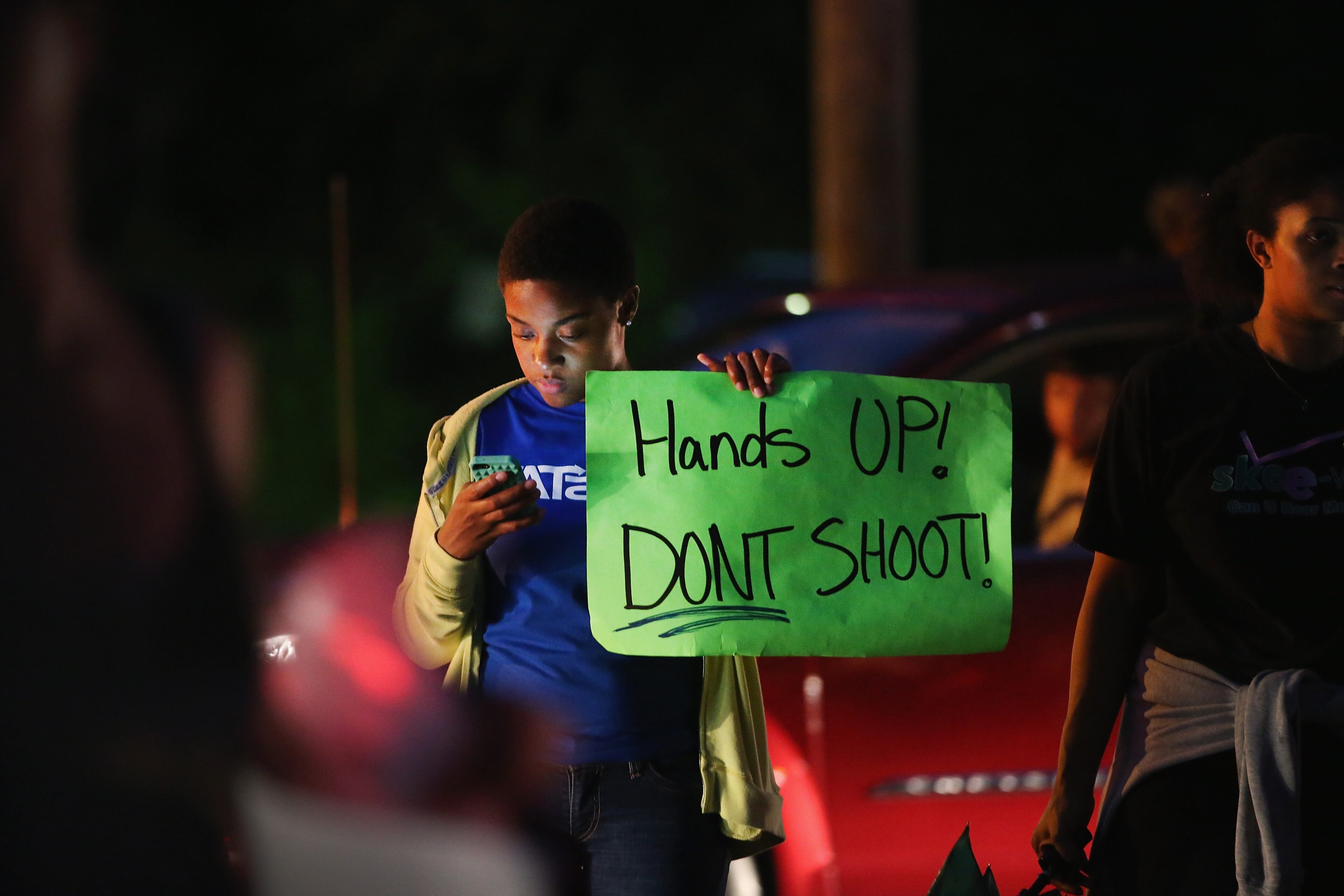 FERGUSON, MO - AUGUST 15: Demonstrators gather along West Florissant Avenue to protest the shooting and death of Michael Brown on August 15, 2014 in Ferguson, Missouri. Brown was shot and killed by a Ferguson police officer on August 9. Protestors raise their hands and chant "Hands up, don't shoot" as a rally cry to draw attention to reports that stated Brown's hands were raised when he was shot. Tonight demonstration again ended with protestors clashing with police followed by more looting. (Photo by Scott Olson/Getty Images)