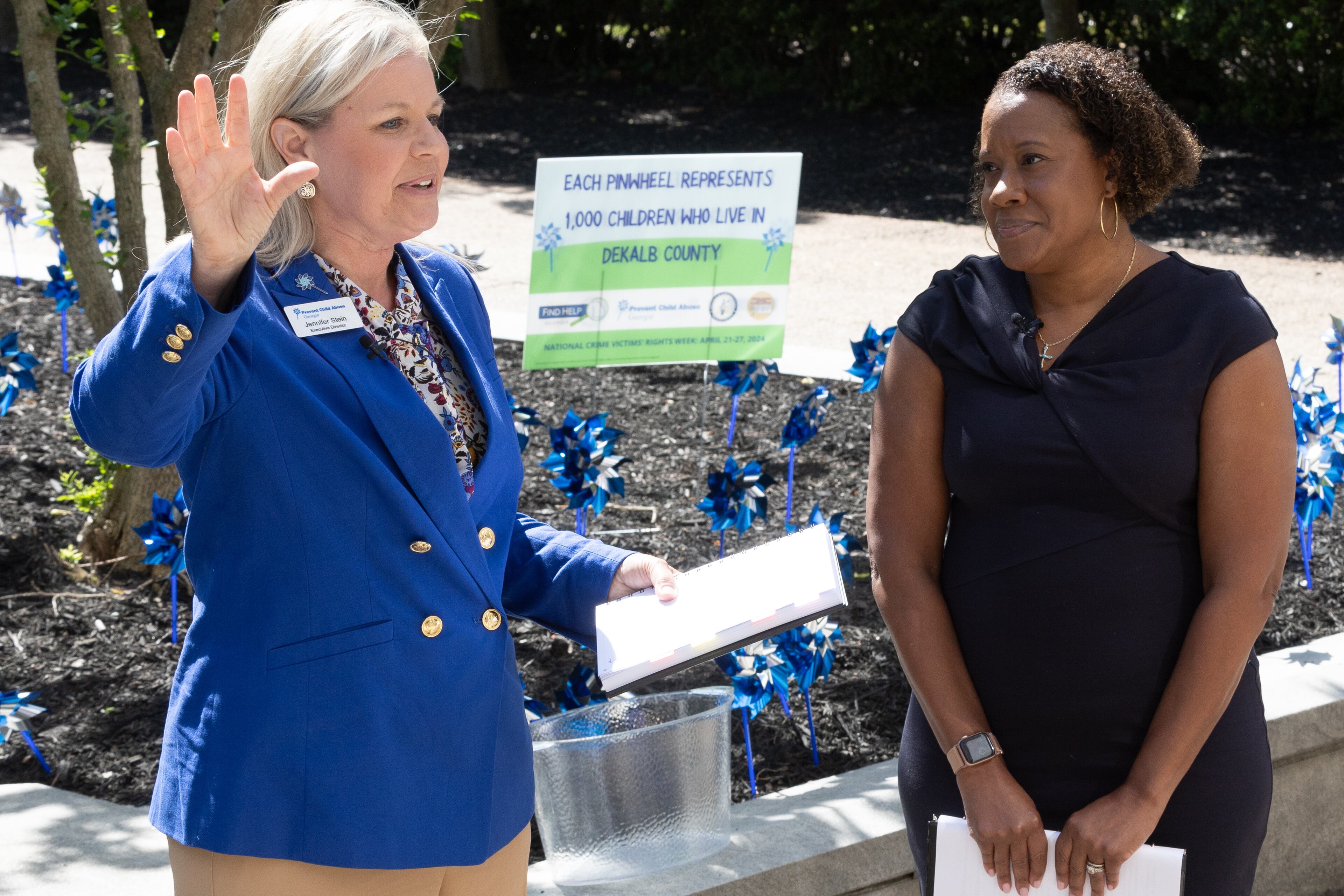 DeKalb County District Attorney Sherry Boston (Right) and Prevent Child Abuse executive Director Jennifer Stein speak to the crowd that gathered in front of the Dekalb County Courthouse on Tuesday, April 23, 2024. (Steve Schaefer / AJC)