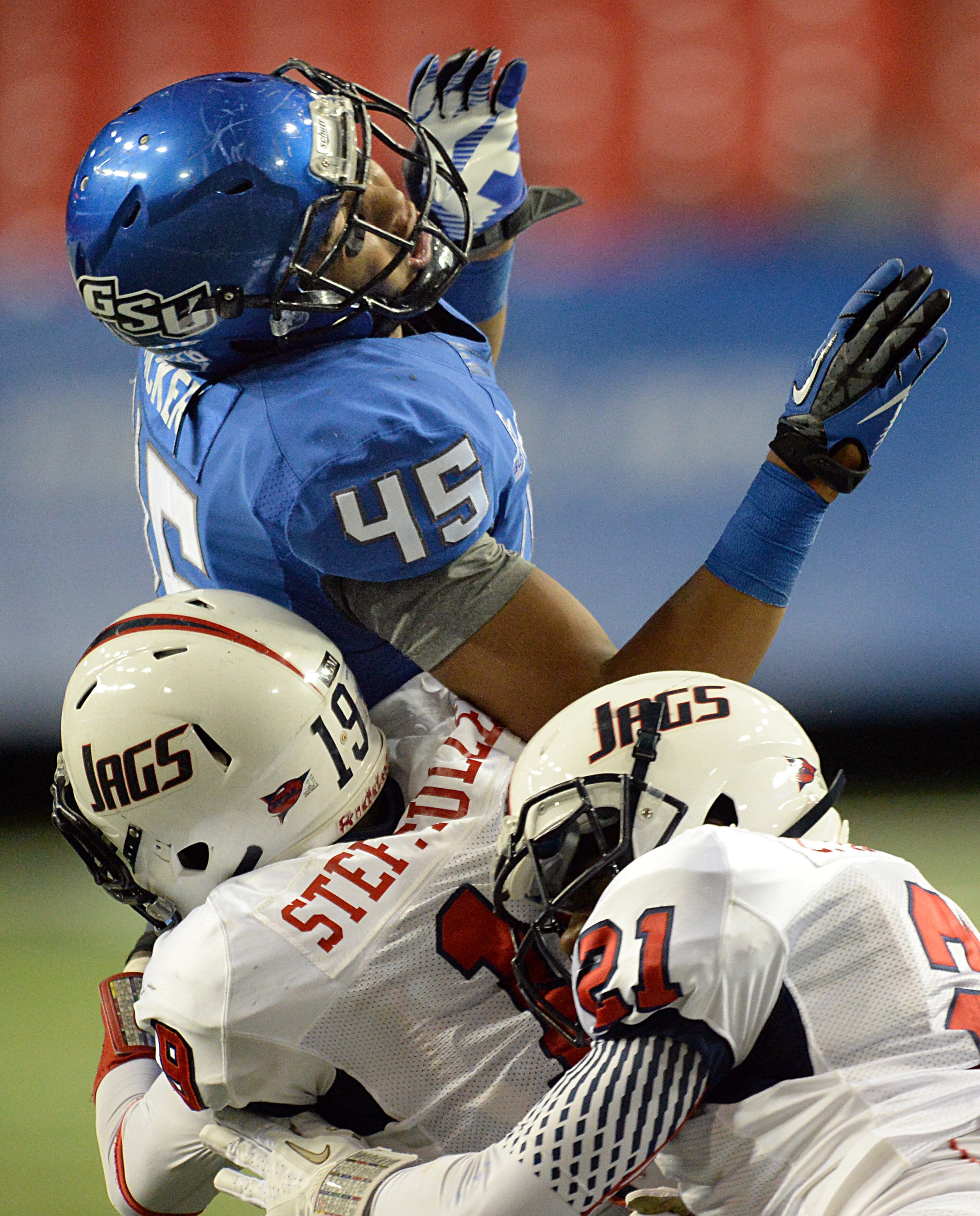 Georgia State Panthers tight end Keith Rucker (45) is hit by South Alabama Jaguars Steffon Fuller (19) and South Alabama Jaguars Charles Harris (21) after he failed to catch a pass in the second half on Saturday, November 30, 2013, at the Georgia Dome. South Alabama Jaguars won 38 - 17.