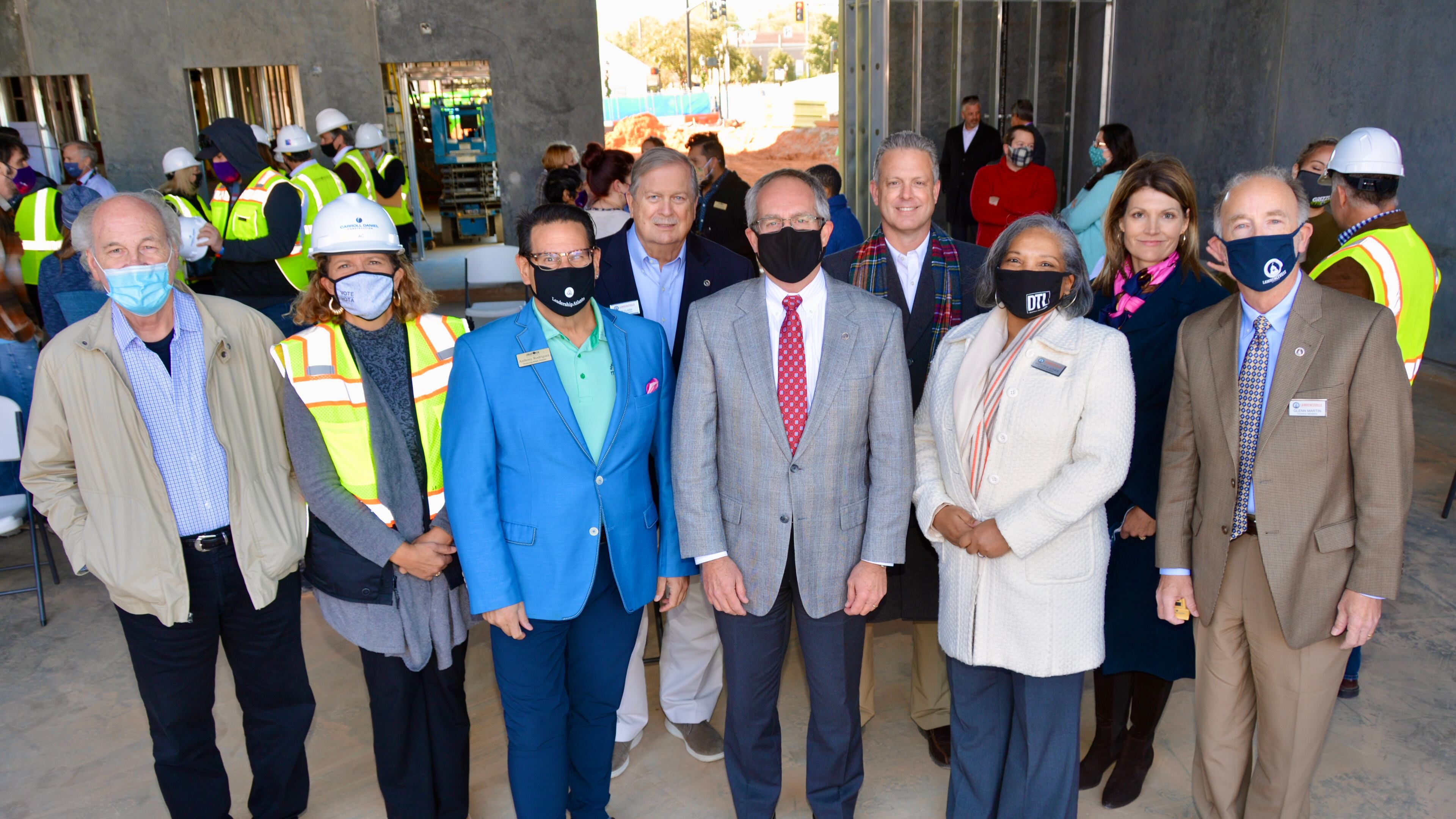 Photo L - R: Randy Foster, Aurora Theatre Board; Ann-Carol Pence, Aurora Theatre; Anthony Rodriguez, Aurora Theatre; Councilman Bob Clarke; Mayor David Still; Chuck Warbington, City Manager; Councilwoman Victoria Jones; Lee Merritt, Downtown Development Authority; and Councilman Glenn Martin gather to celebrate placement of the final beam at the Lawrenceville Performing Arts Center. (Courtesy City of Lawrenceville)
