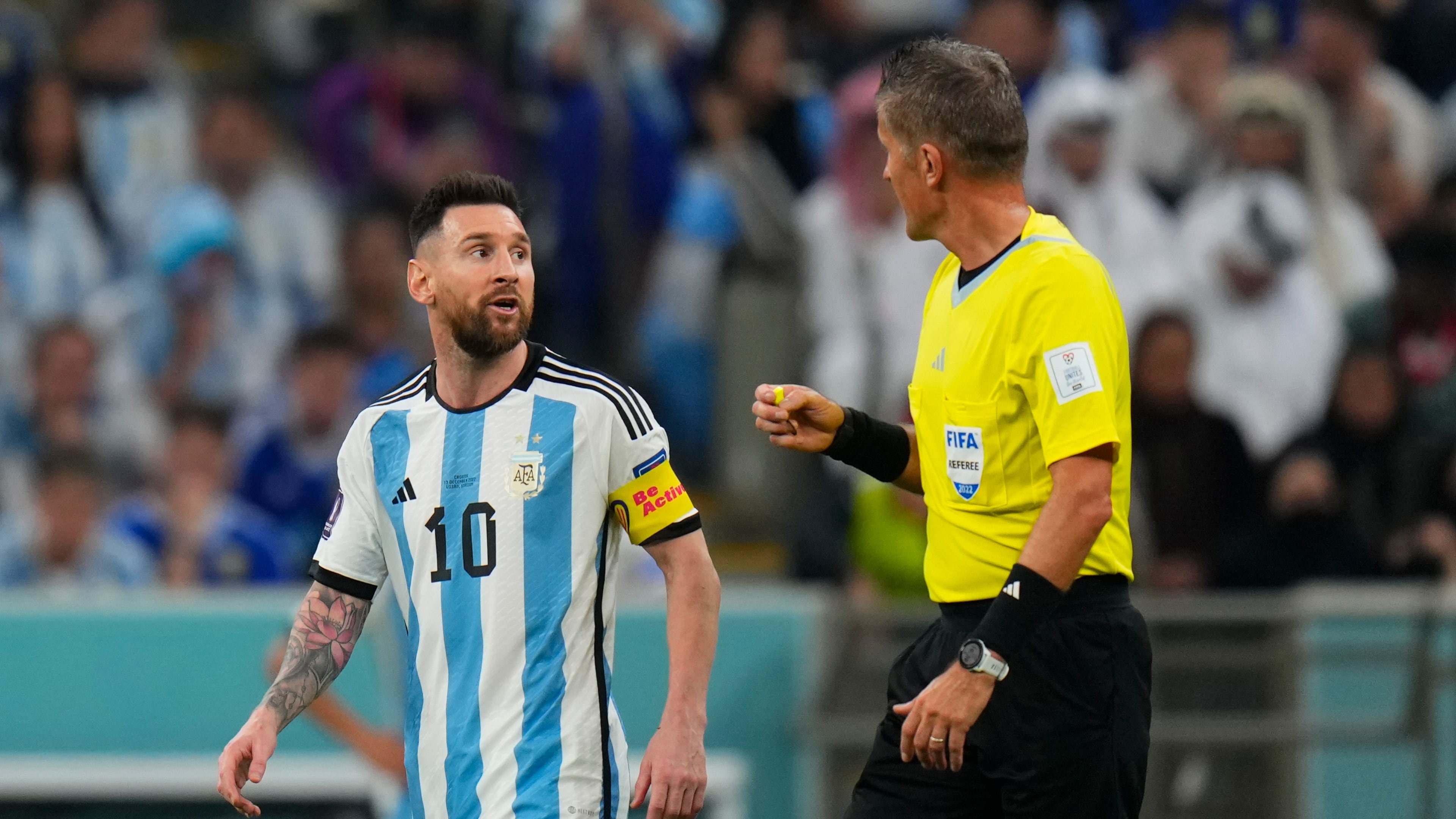 FILE - Referee Daniele Orsato talks to Argentina's Lionel Messi, left, during the World Cup semifinal soccer match between Argentina and Croatia at the Lusail Stadium in Lusail, Qatar, Dec. 13, 2022. (AP Photo/Petr David Josek, file)