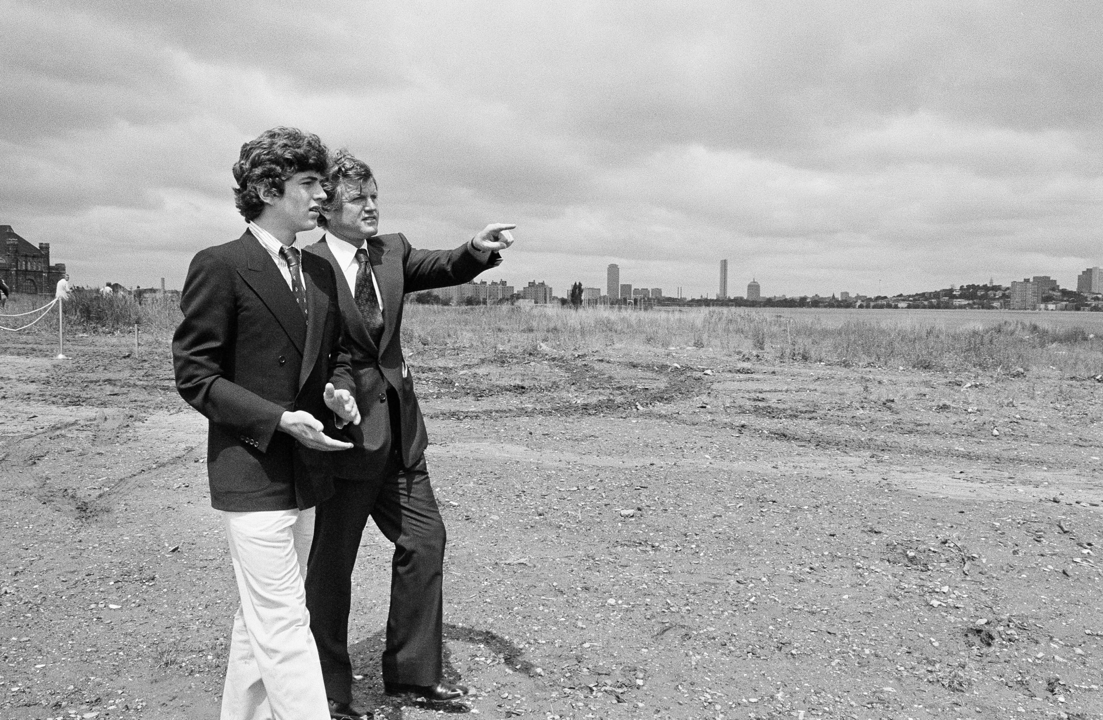 Sen. Edward M. Kennedy tours the sandy site of the John F. Kennedy Library Sunday, June 12, 1977 in Boston, with his nephew, John Jr., son of the late President. They were in Boston for groundbreaking ceremonies for the library. (AP Photo)