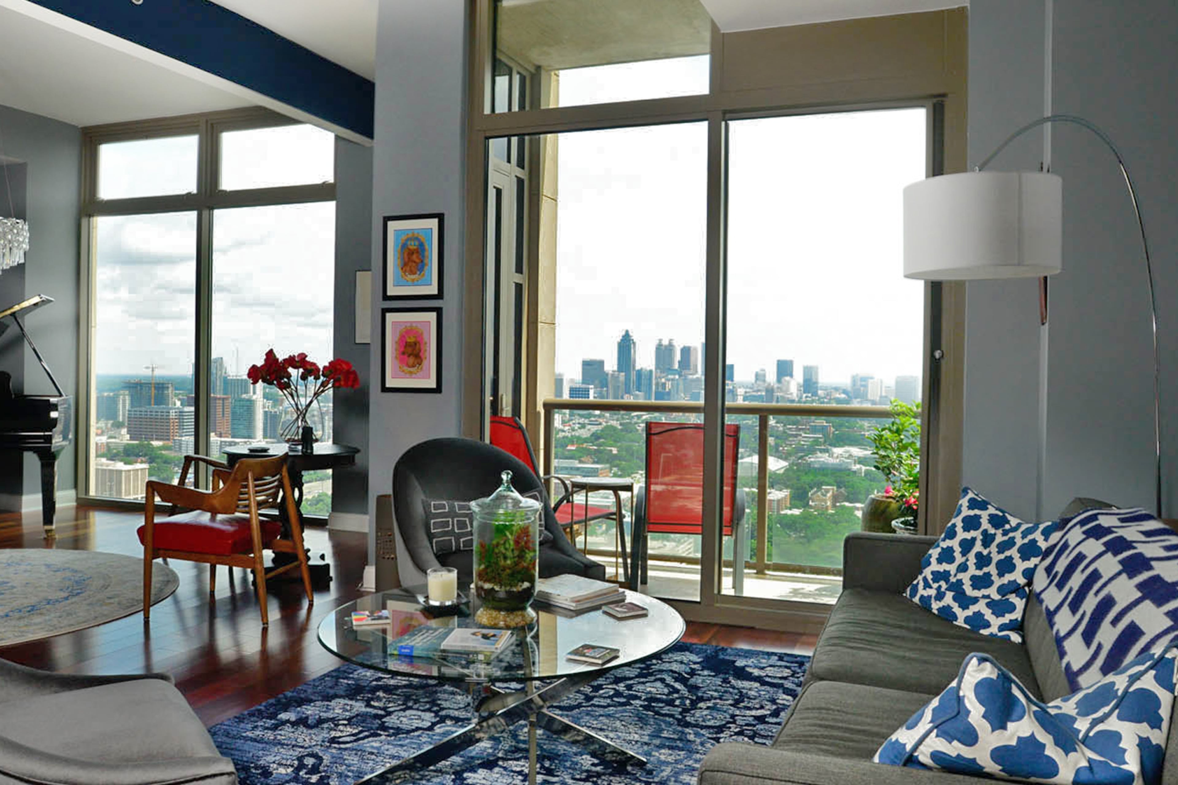 A sofa in slate gray from Room & Board and accent chairs from Mitchell Gold + Bob Williams are among the modern furniture in the condo, which also has a gallery of photos from the homeowners' visit to Spain.