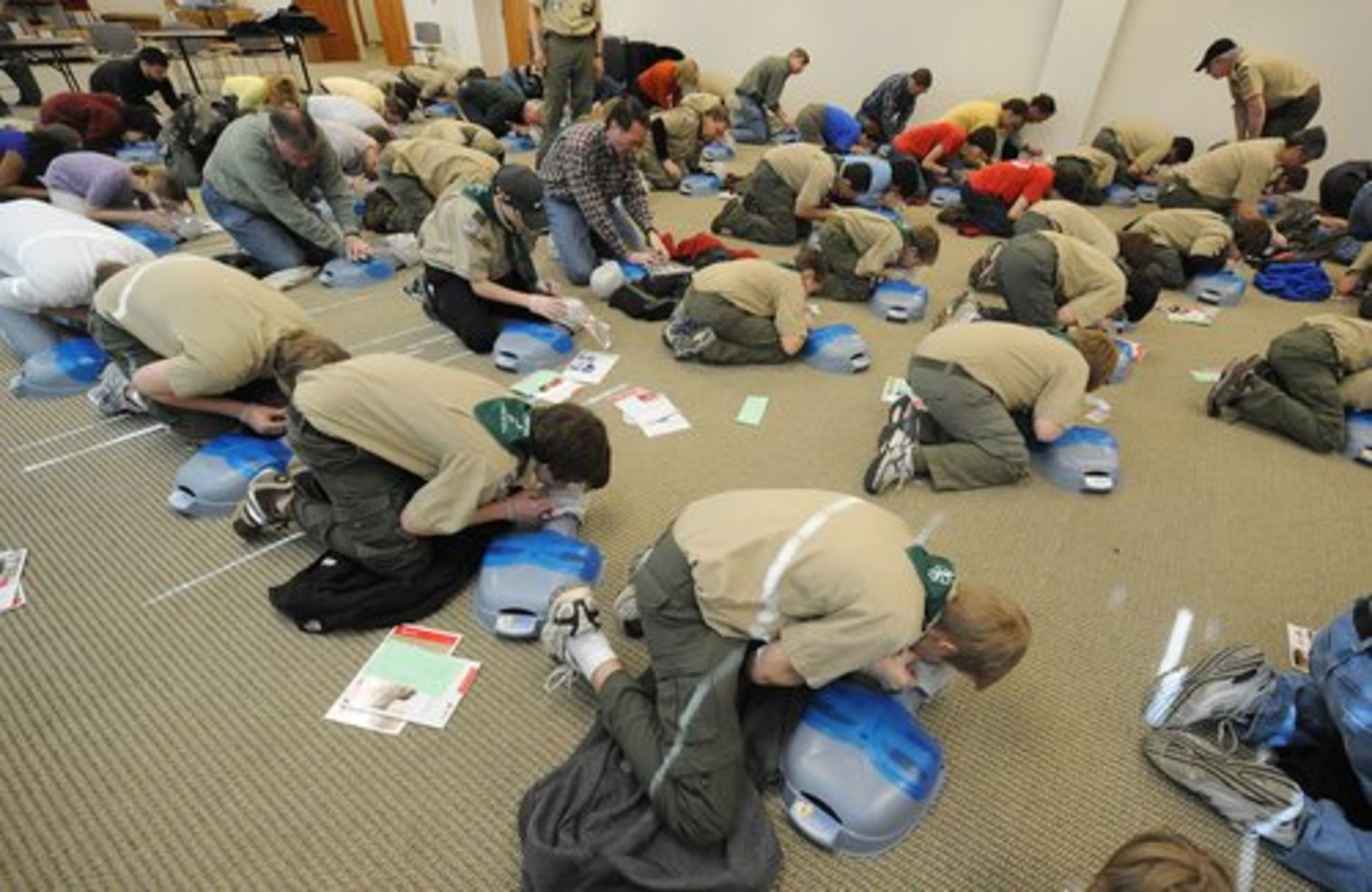 A room filled with Boy Scouts and Scout leaders perform mouth to mouth resisitation on dummies during a Cardio Pulmonary Resuscitation (CPR) class on Scout CPR Saturday at the Boy Scouts of America's Atlanta Area Council Office on Saturday, March 6, 2010. "We are training youth to be first responders instead of bystanders."said Wayne Miller, Atlanta Area Council Activities Chairperson.