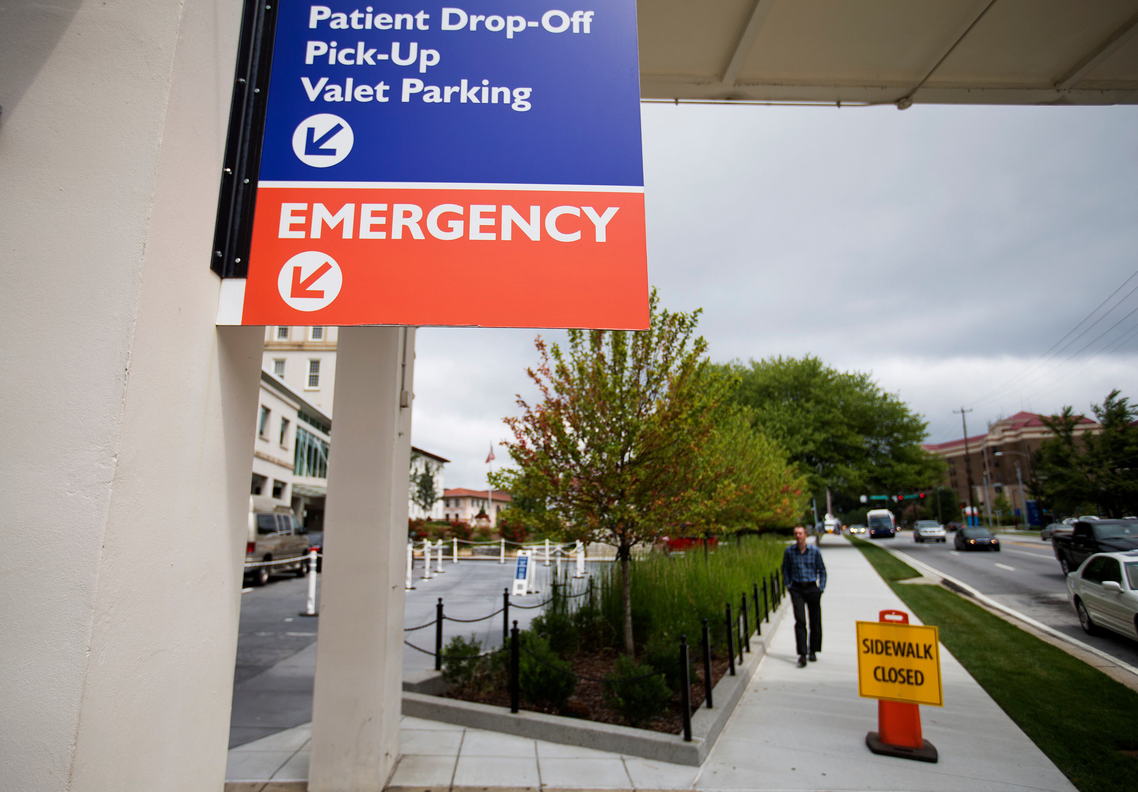 Signs point toward the emergency department at Emory University Hospital as the hospital prepares to receive an American aid worker who has been diagnosed with Ebola, Friday, Aug. 1, 2014, in Atlanta. The hospital has a special isolation unit that was built in collaboration with the Centers for Disease Control and Prevention that's used to treat people with certain serious infectious diseases. (AP Photo/David Goldman)