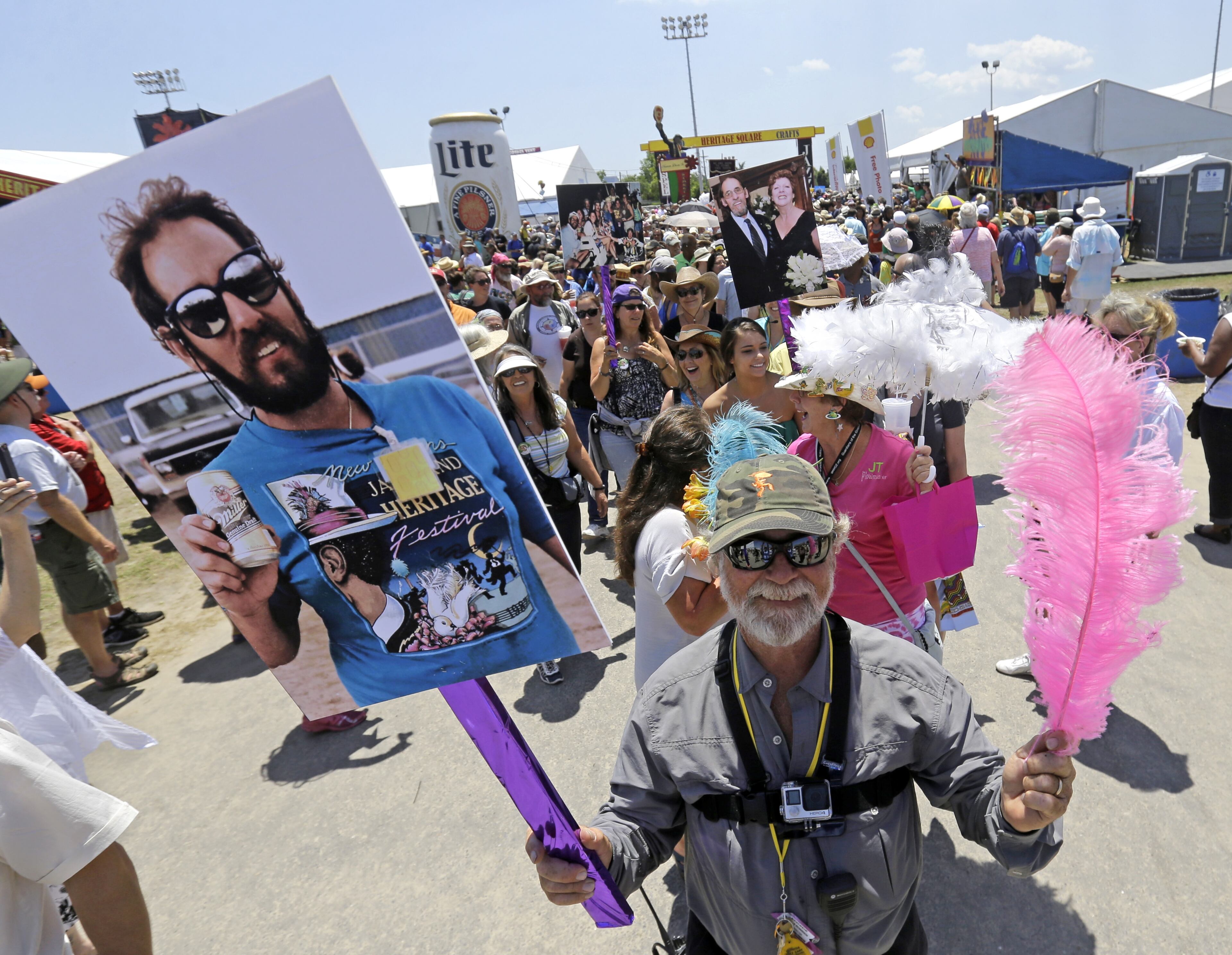 Tague Richardson, sight director for New Orleans Jazz and Heritage Festival, leads a 'jazz funeral' procession with friends, co-workers and festival-goers in memory of longtime Jazz Fest employee JT Tamberella, who died this past year, at the New Orleans Jazz and Heritage Festival in New Orleans, Friday, May 1, 2015. (AP Photo/Gerald Herbert)