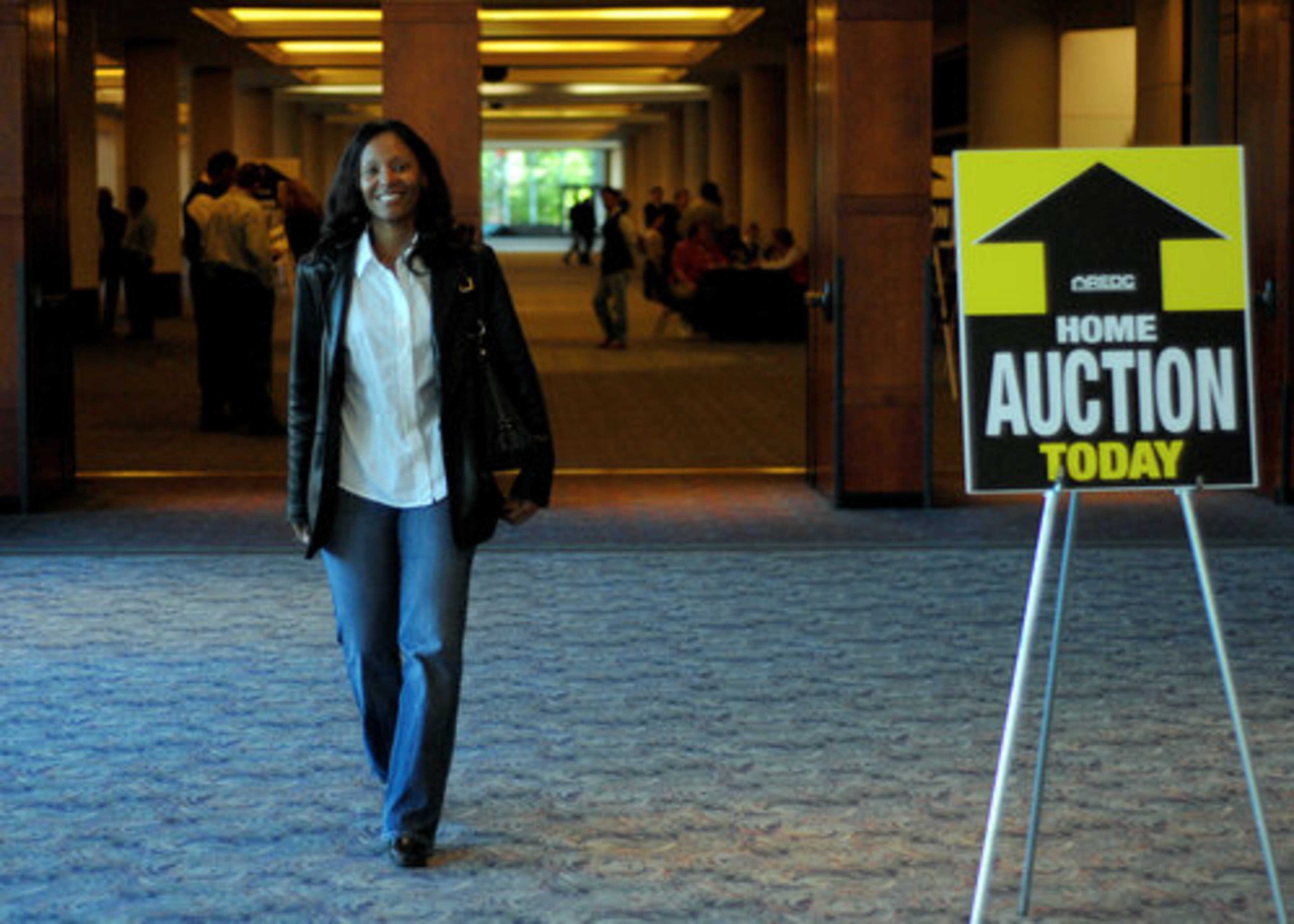 Successful bidder Nicole Brown, of Dallas, leaves the auction after buying a foreclosed house in Dallas for a little over $73,000. The house was valued at $129,000. Brown said this is her seventh home purchase, but her first auction.