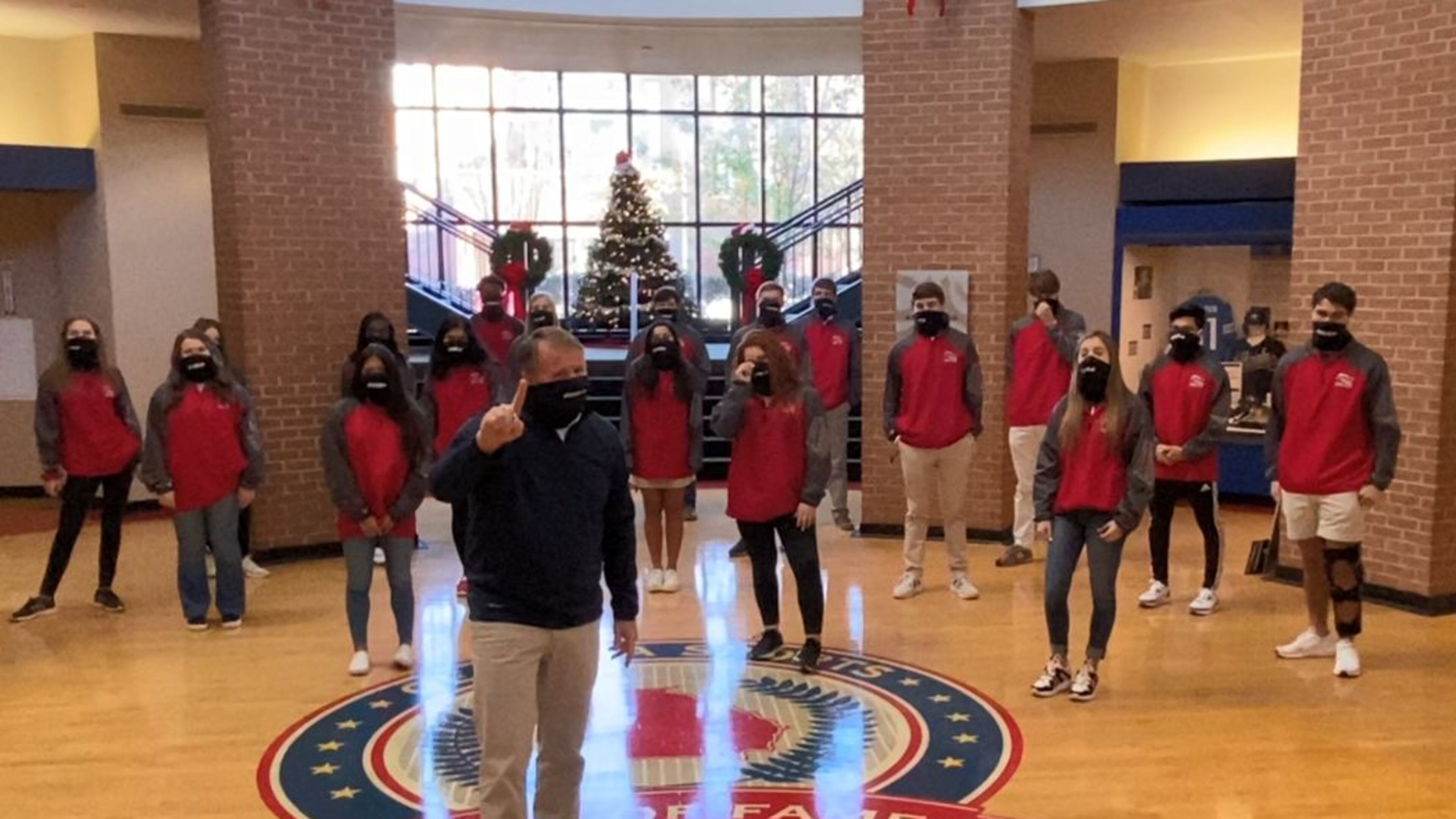 GHSA executive director Robin Hines conducts the association’s universal coin toss from the Georgia Sports Hall of Fame in Macon. He’s joined by the GHSA’s student-athlete advisory committee members.