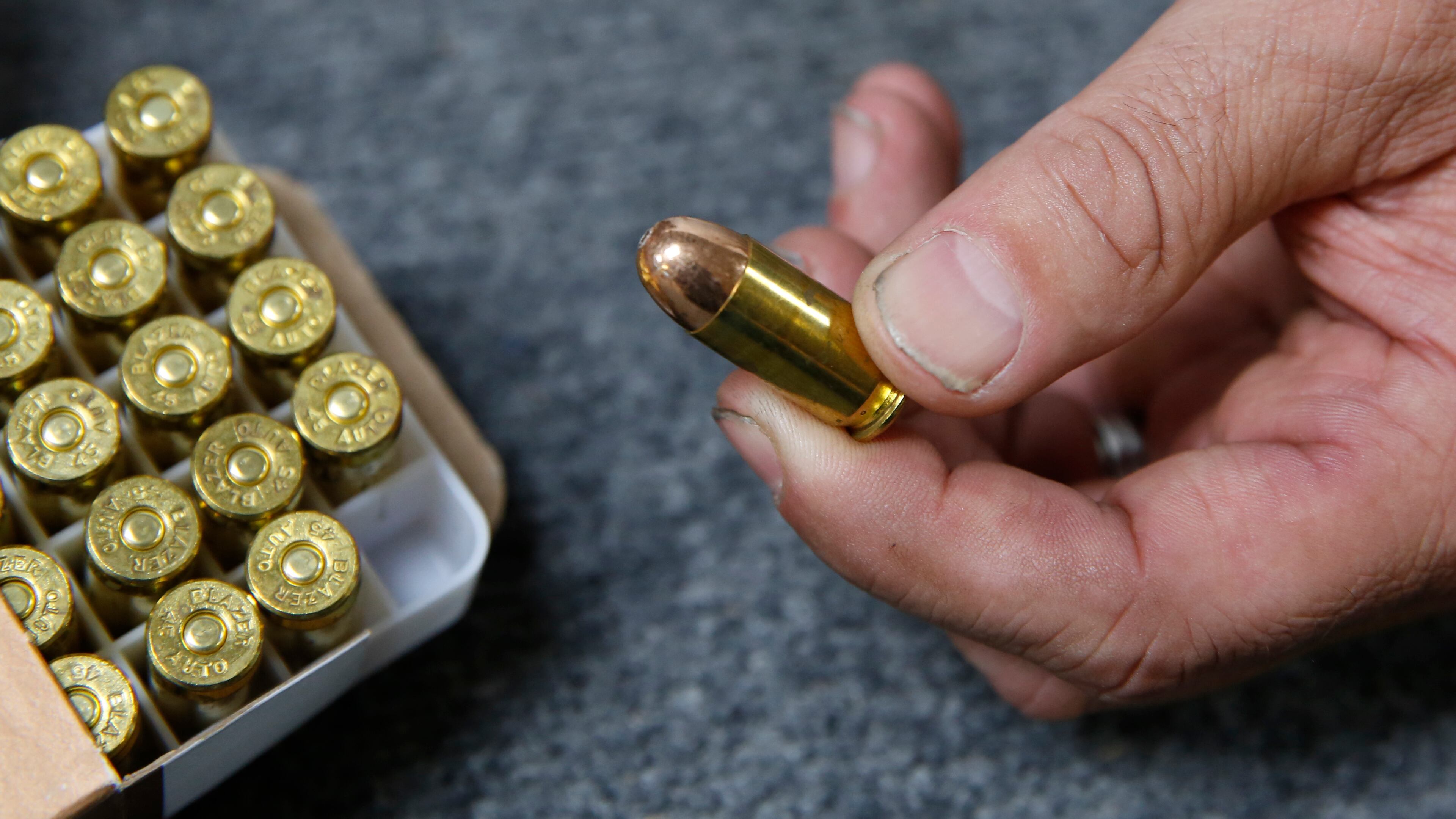 FILE - In this June 11, 2019, file photo, Chris Puehse, owner of Foothill Ammo, displays .45-caliber ammunition for sale at his store in Shingle Springs, Calif. A federal judge on Thursday, April 23, 2020, blocked a California law requiring background checks for people buying ammunition, ruling the restrictions violate the constitutional right to bear arms. U.S. District Judge Roger Benitez of San Diego ruled in favor of the California Rifle & Pistol Association, which asked him to stop the checks and related restrictions on ammo sales. (AP Photo/Rich Pedroncelli, File)