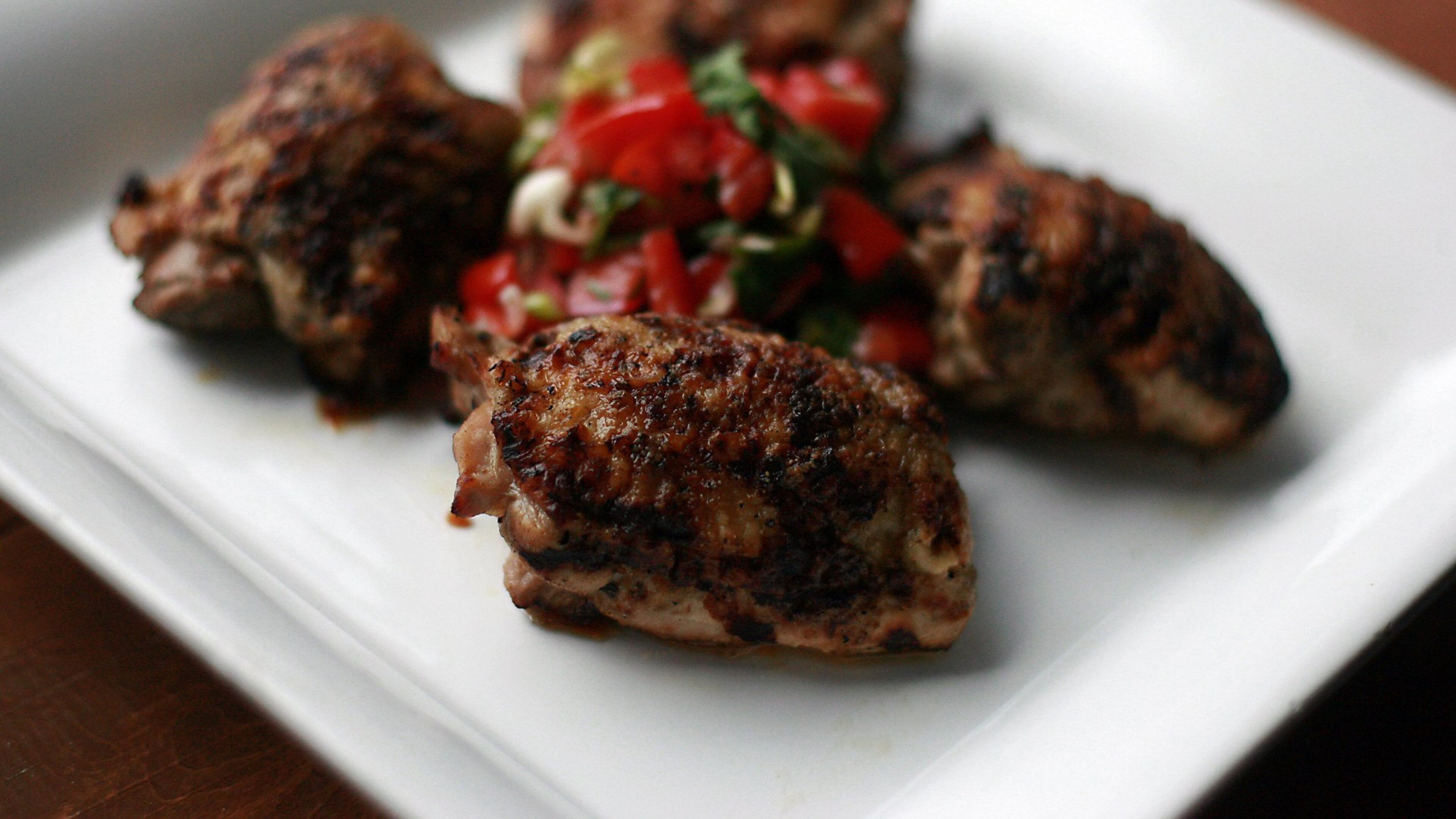 Marinated Grilled Chicken Thighs with Tomato Salsa. (Kimberly P. Mitchell/Detroit Free Press/TNS)