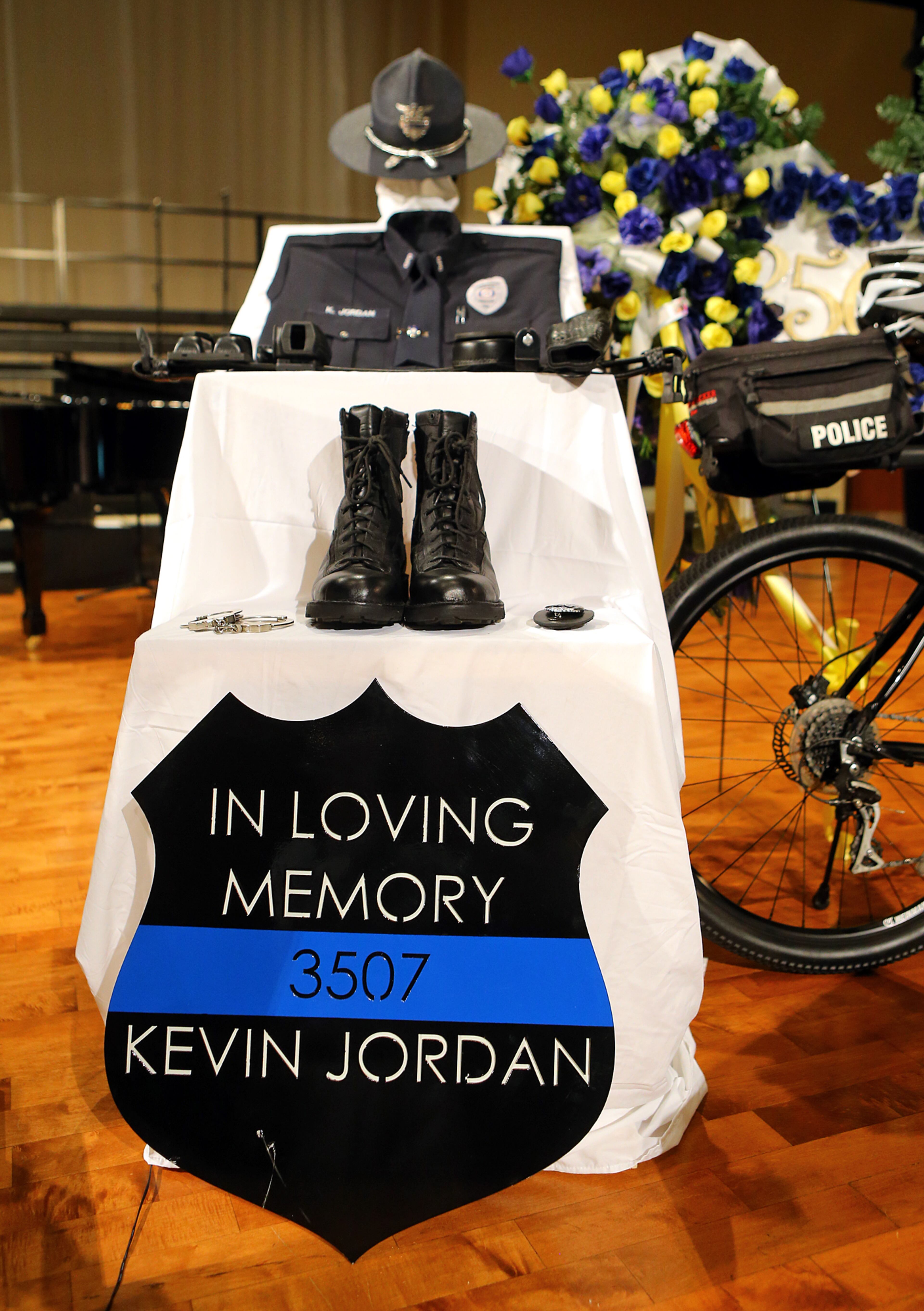 The funeral for Griffin police officer Kevin "Shogun" Dorian Jordan, 43, was held Monday at the Oak Hill Baptist Church in Williamson. Jordan, a four-year veteran of the Griffin police force and father of seven, was shot and killed May 31 while working off-duty at a Waffle House on U.S. 41. Jordan was attempting to remove three drunken and disruptive customers from the restaurant when the shooting occurred. Police said Chantell Mixon, 28, put up a fight in the parking lot while Jordan tried to arrest her. Police said Mixon's boyfriend, 30-year-old Michael Dwayne Bowman, pulled out a gun and shot Jordan at least three times. CURTIS COMPTON / CCOMPTON@AJC.COM