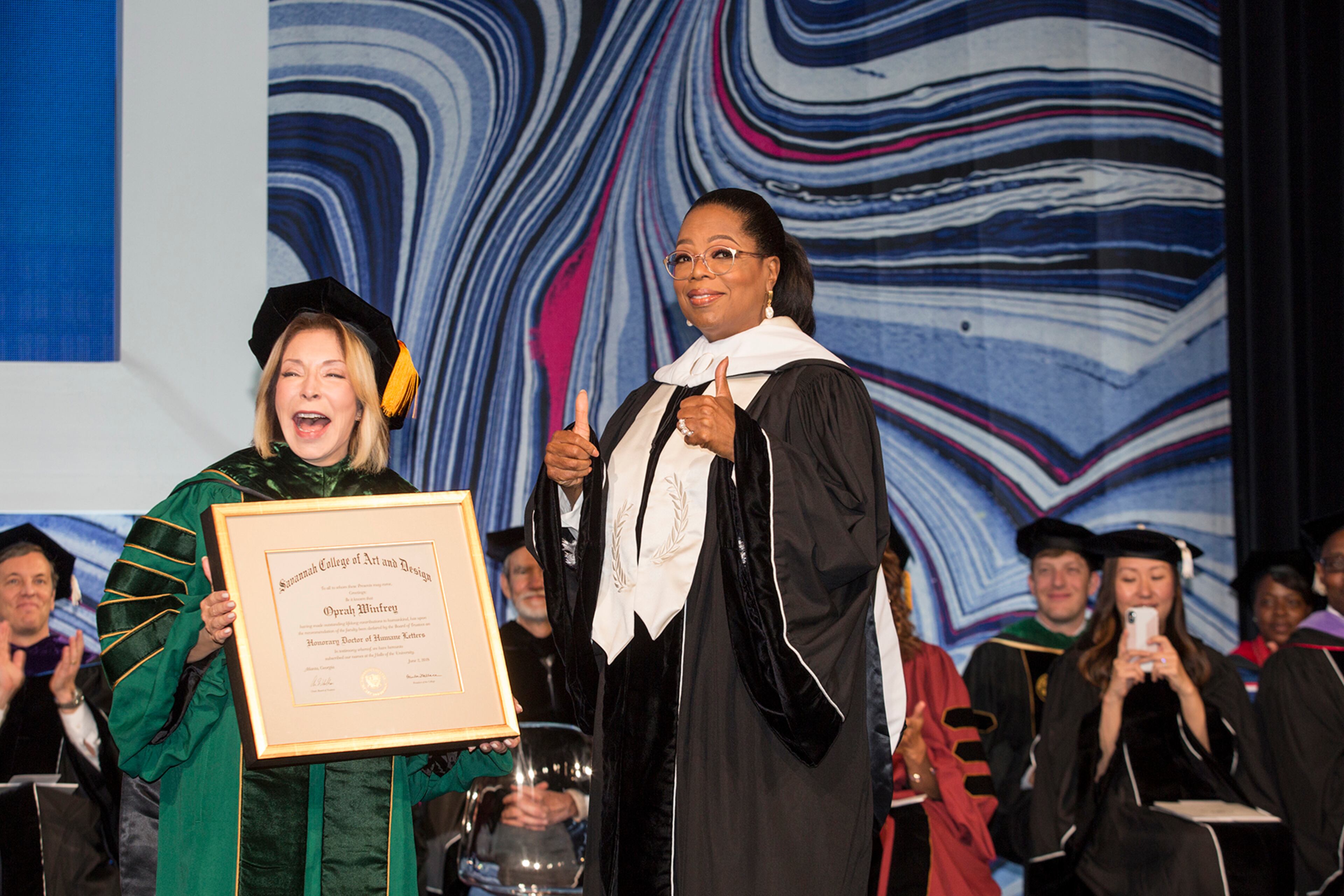 Oprah Winfrey receives an honorary degree from SCAD founder and president Paula Wallace at the Georgia World Congress Center June 2, 2018. Photography Courtesy of SCAD
