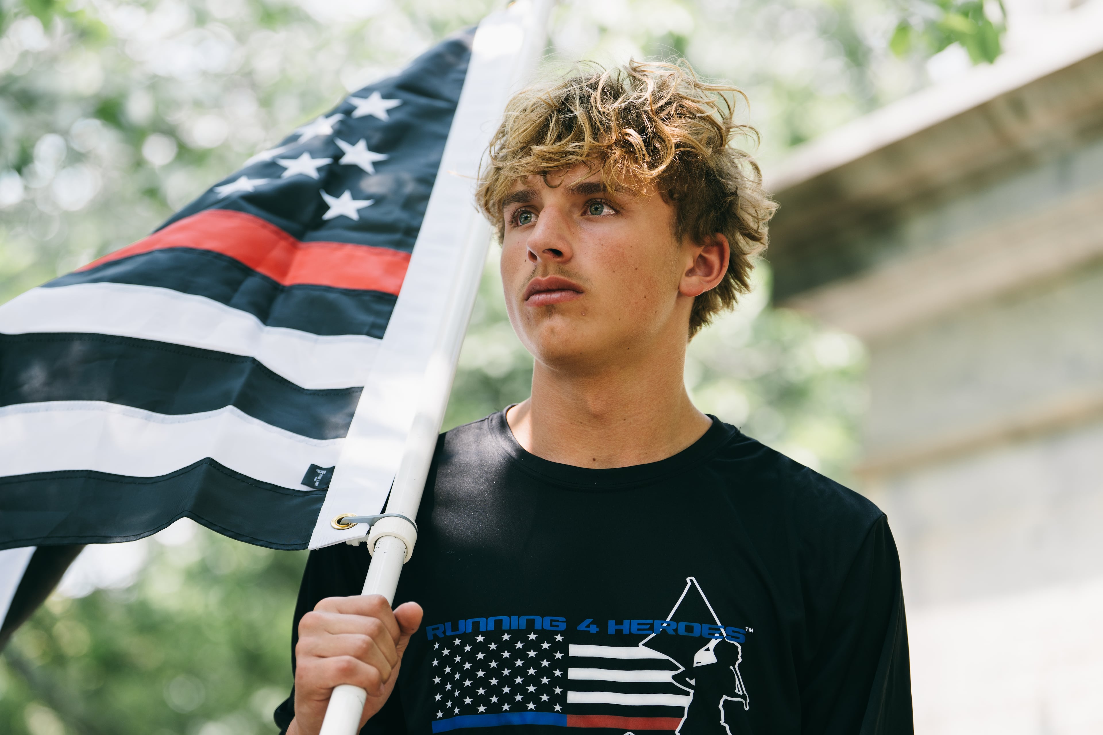 Andrew Collinson, 16, poses for a portrait in the Gainesville Square July 30, 2026, the day before he undertakes his final run for the nonprofit Running 4 Heroes Inc. Collinson has run over 130 miles for the organization, honoring first responders whose lives have been lost in service (Olivia Bowdoin for the AJC).