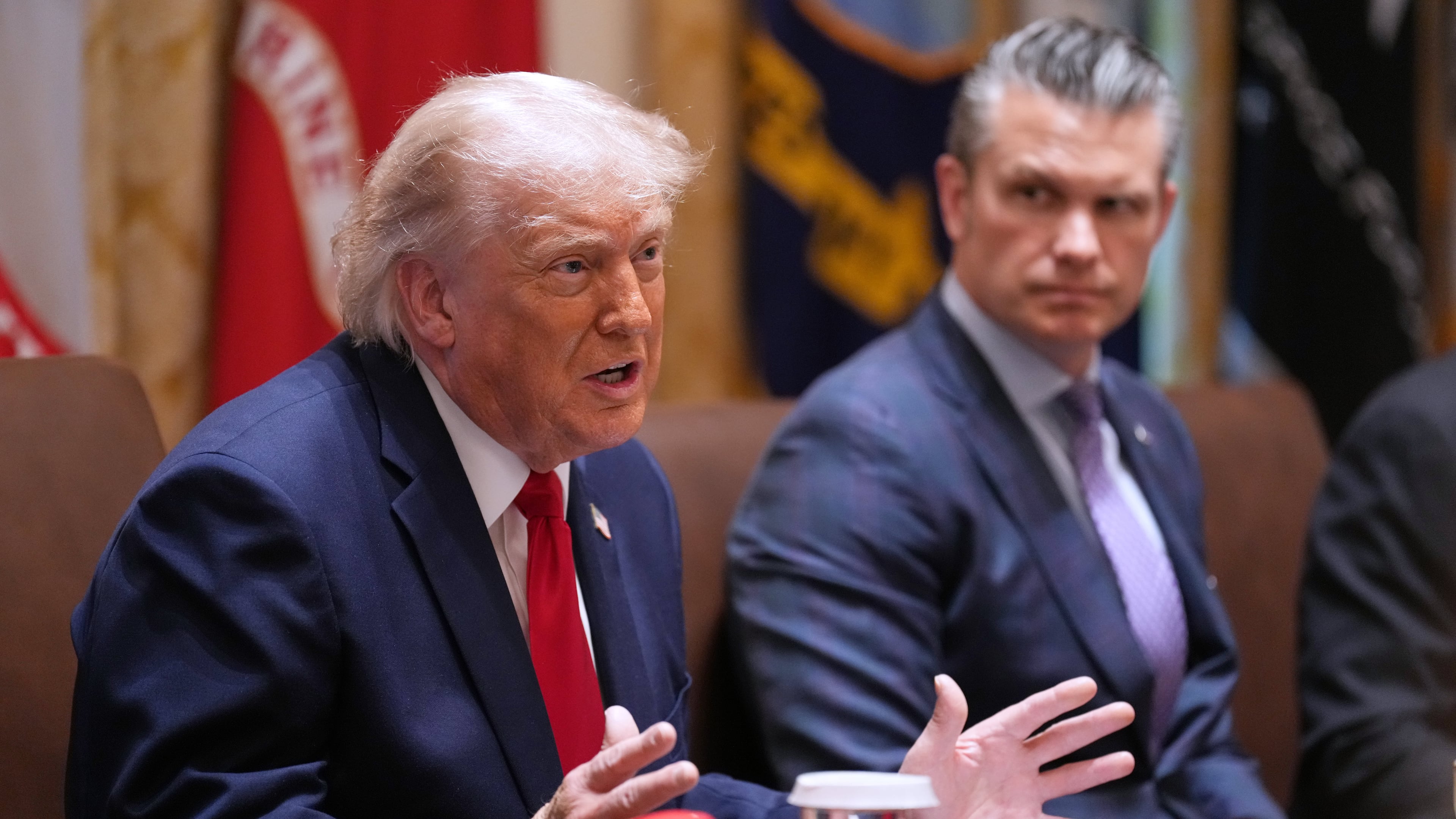 President Donald Trump speaks during a Cabinet meeting at the White House, Wednesday, May 27, 2026, in Washington, as Secretary of Defense Pete Hegseth, looks on. (AP Photo/Jacquelyn Martin)