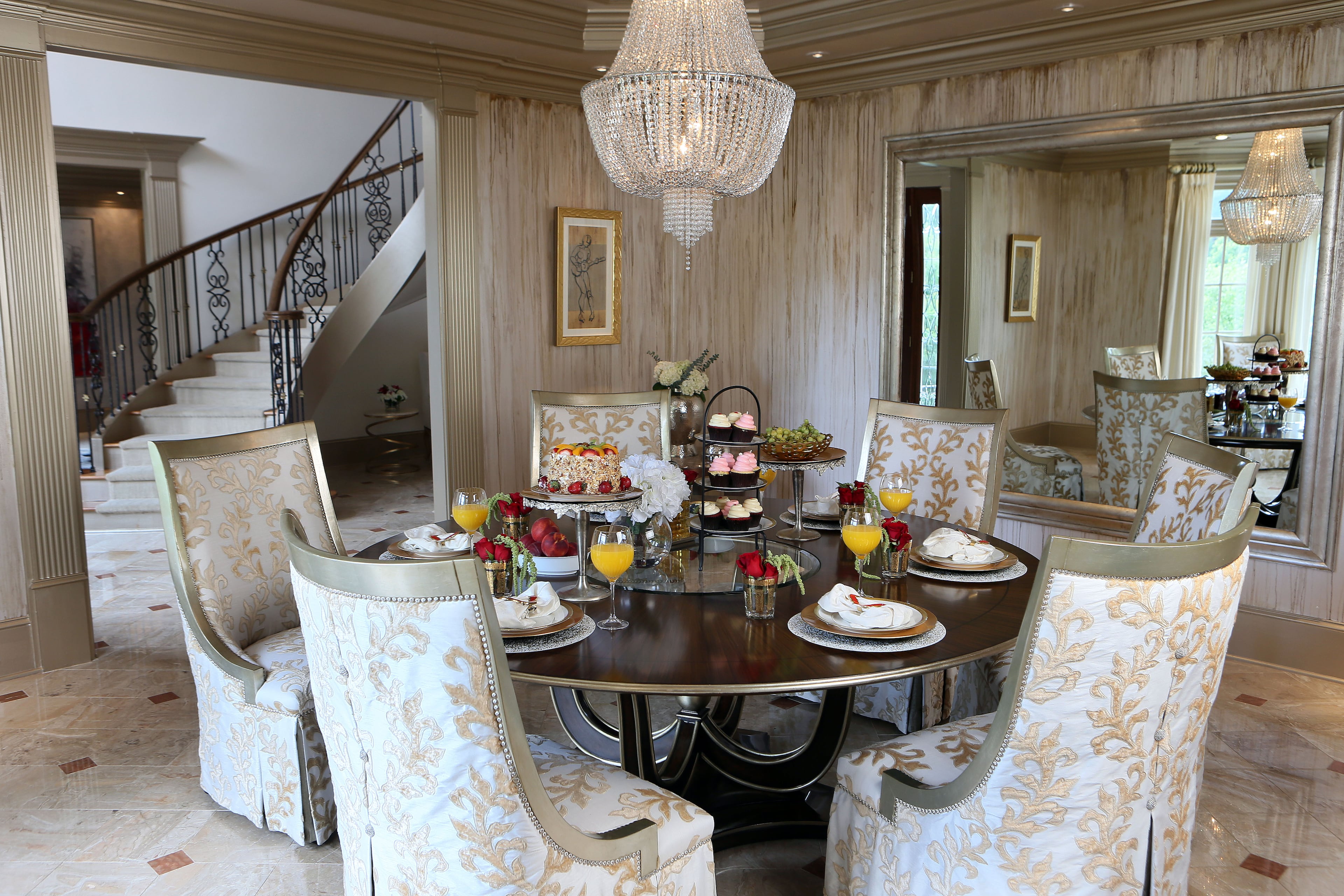 A large mirror adds depth to the dining room.