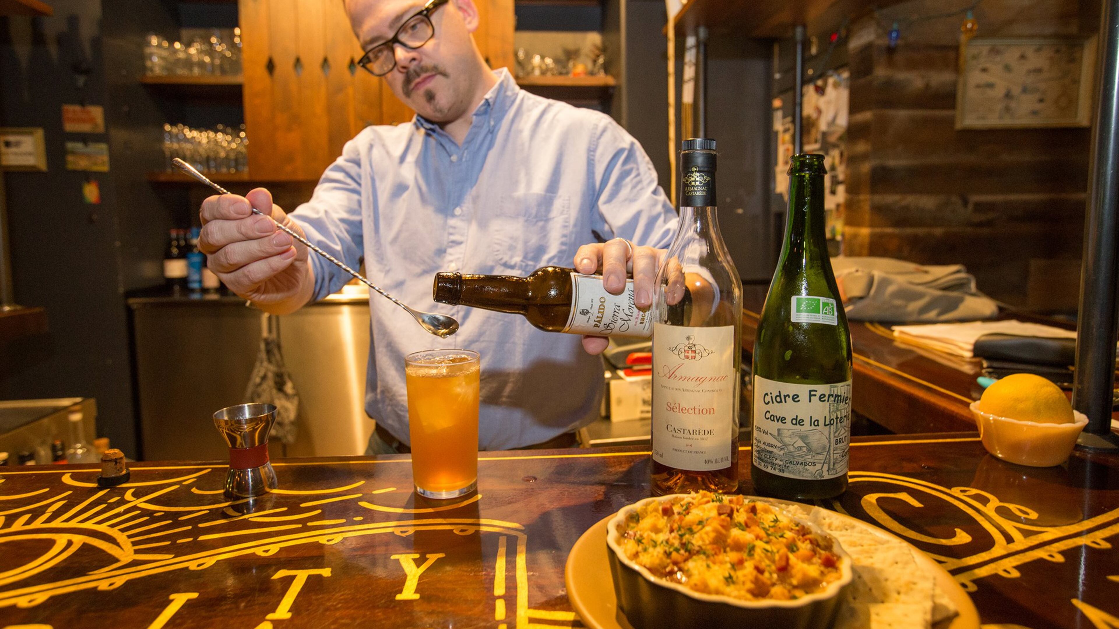 Greg Best mixes cider, brandy, bitters and tops the cocktail with sherry to create an Old Brick Wall for pairing with oysters gratin at Ticonderoga Club in Krog Street Market. (Jenni Girtman / Atlanta Event Photography)