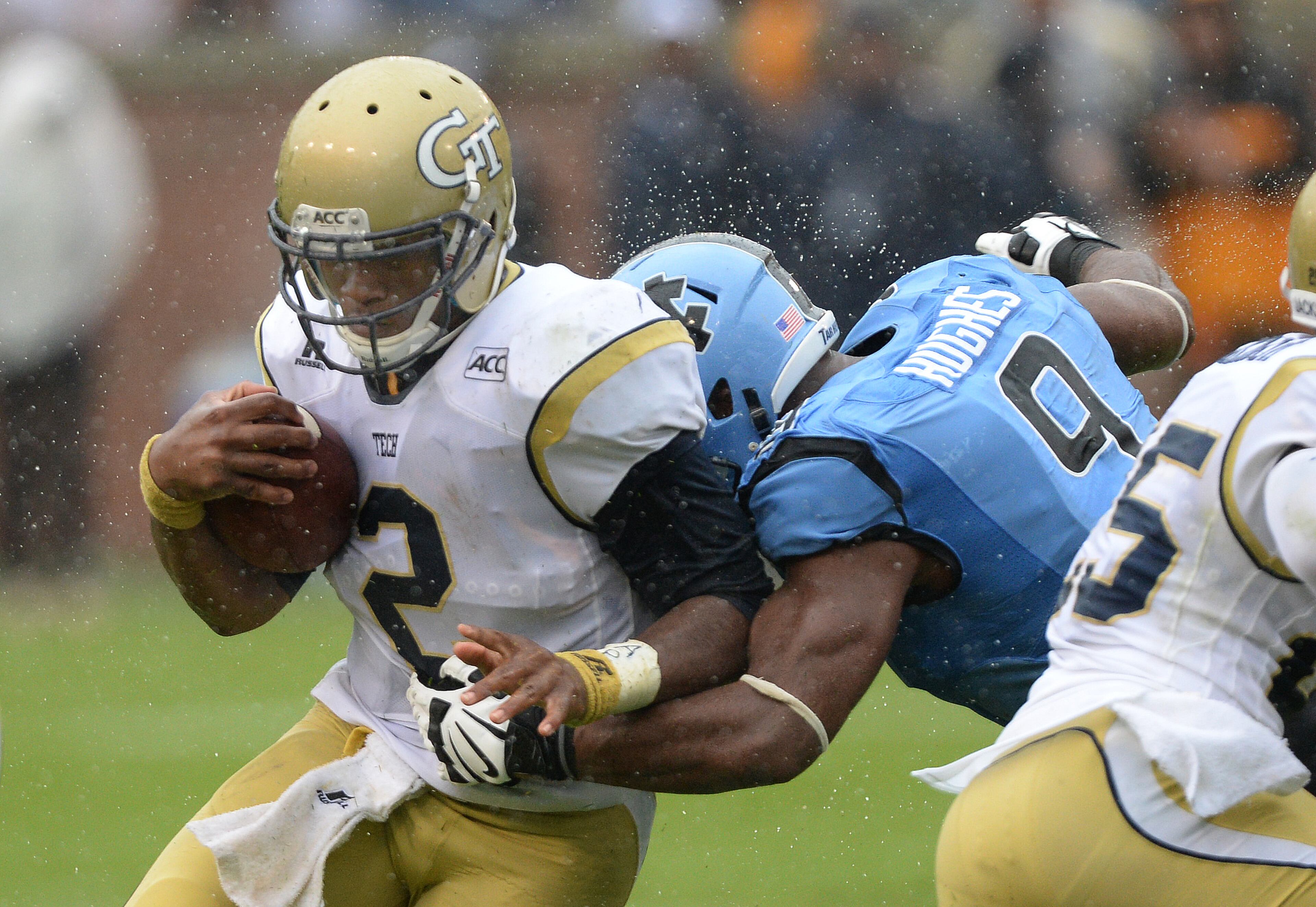 Georgia Tech quarterback Vad Lee (2) is hit by North Carolina's Travis Hughes (9) in the second quarter.
