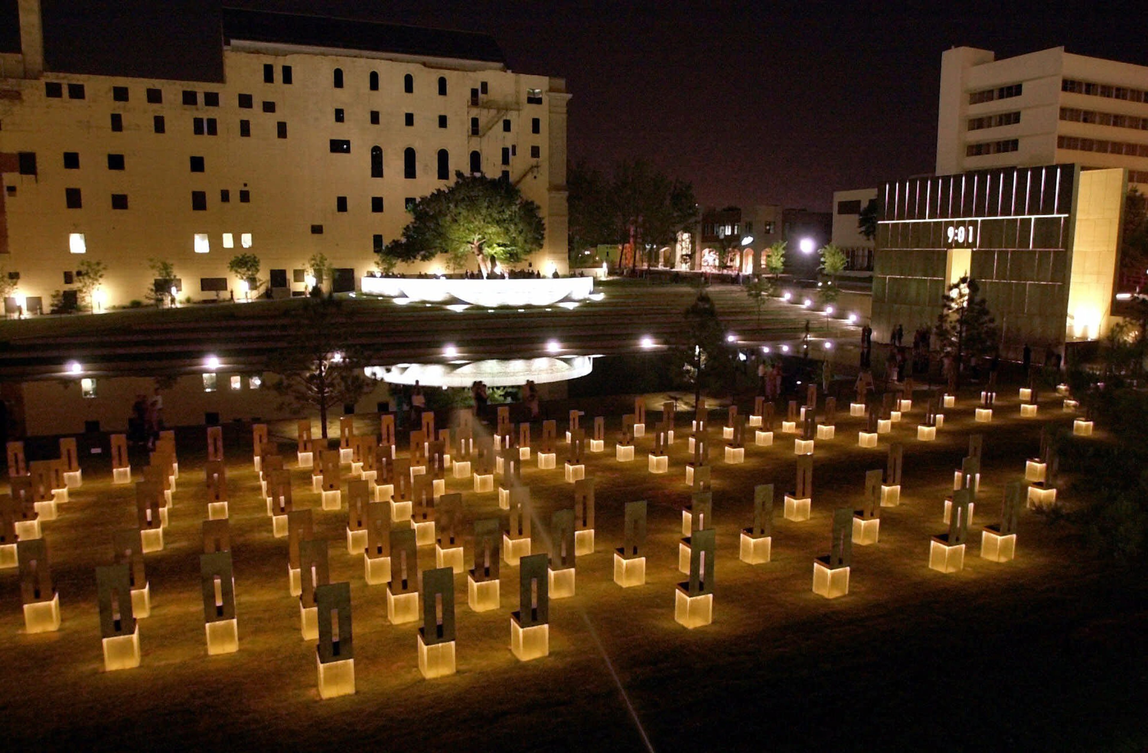 In this May 3, 2001 file photo, a view from the plaza overlooking the Oklahoma City National Memorial site is seen. There are 168 chairs, one for each of the victims killed in the bombing of the Alfred P. Murrah Federal Building April 19, 1995. The survivors' tree and the old Journal Record building are reflected in the reflection pool. A memorial to the bombing�s victims now sits on the former site of the federal building, and a nearby building that was damaged in the bombing houses an interactive museum. Each year on the bombing' anniversary, victim's family members, survivors, rescue workers and others return to the memorial for a remembrance ceremony. (AP Photo/J. Pat Carter)