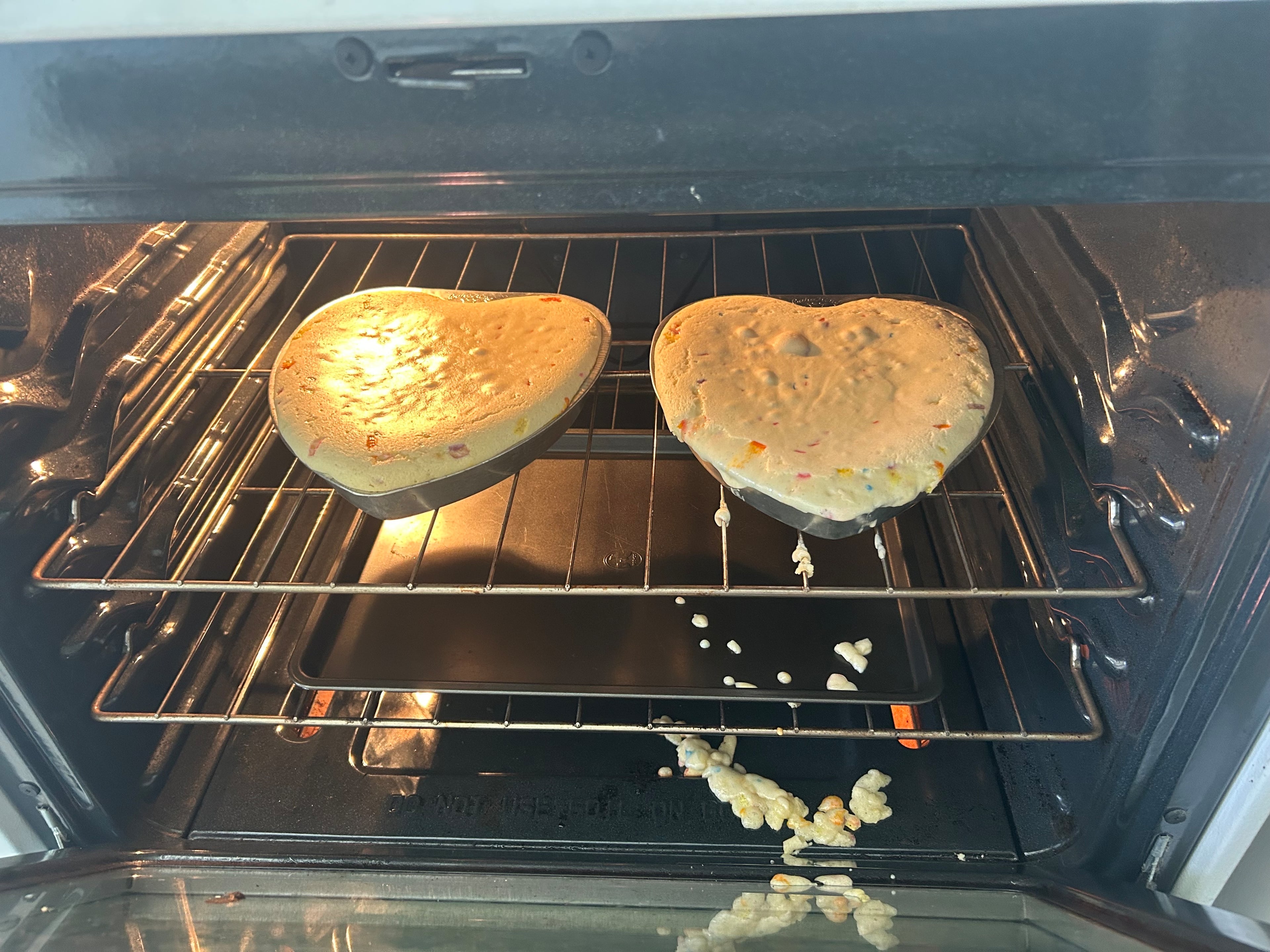 After overfilling the cake tins, batter splattered on the oven floor. Fortunately, the cakes survived. (Olivia Wakim/AJC)