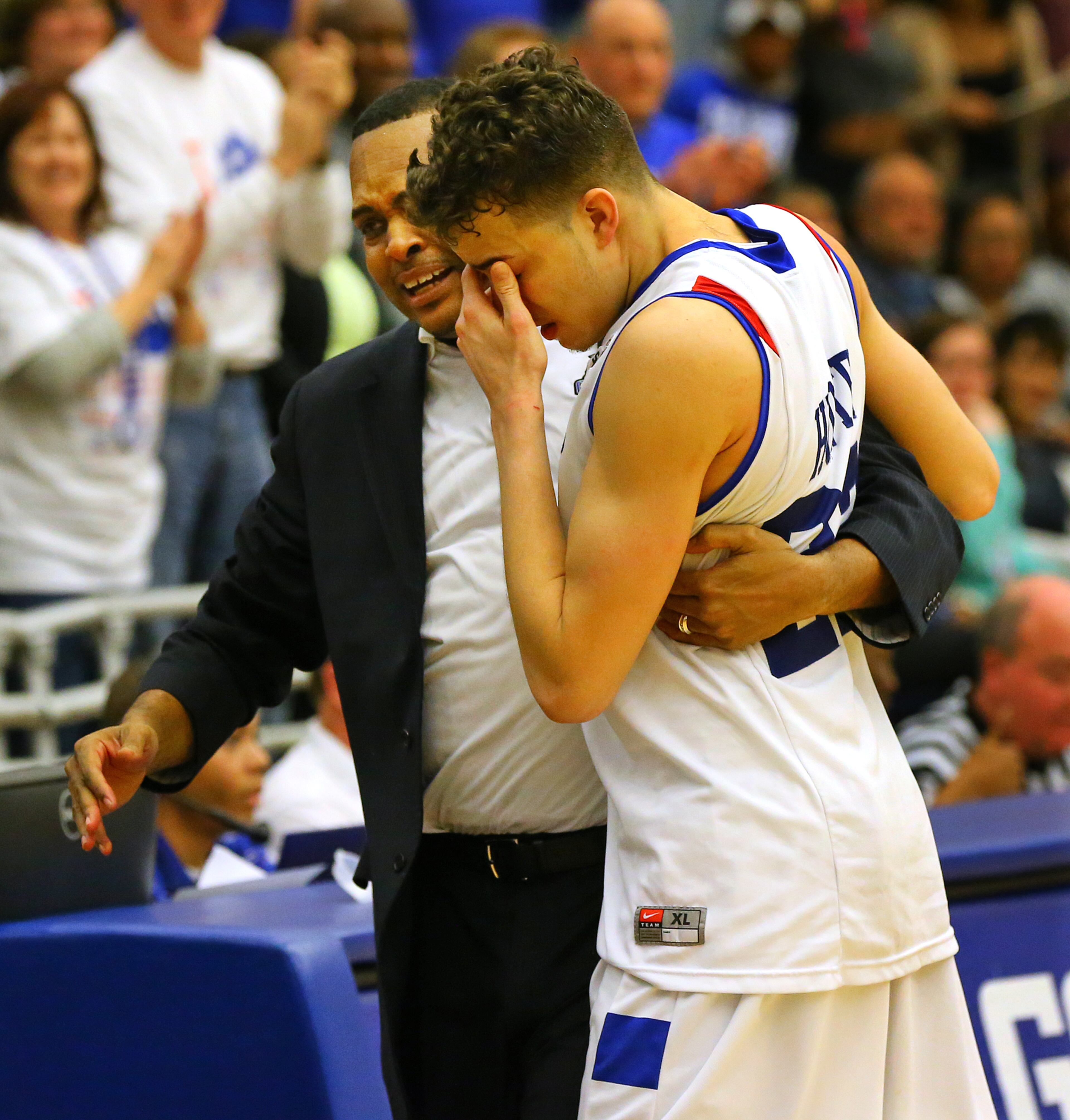 Georgia State head coach Ron Hunter and his son R.J. Hunter become emotional as they embrace after winning the Sun Belt men's basketball regular season championship beating Georgia Southern 72-55 in a basketball game on Saturday, March 7, 2015, in Atlanta.