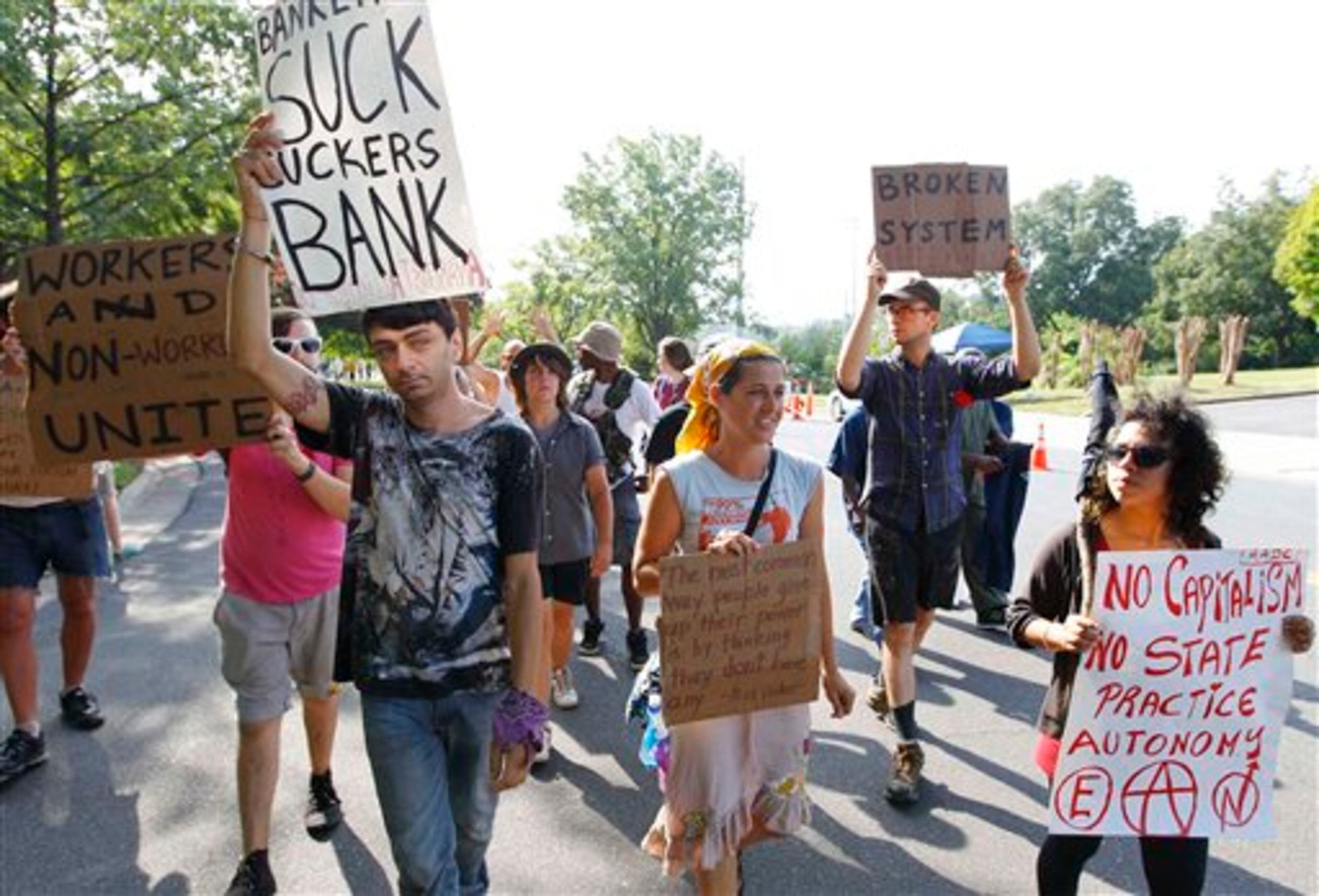 Demonstrators march in a Labor Day parade, Monday, Sept. 3, 2012, in Charlotte, N.C. Demonstrators are protesting before the start of the Democratic National Convention. (AP Photo/Chuck Burton)