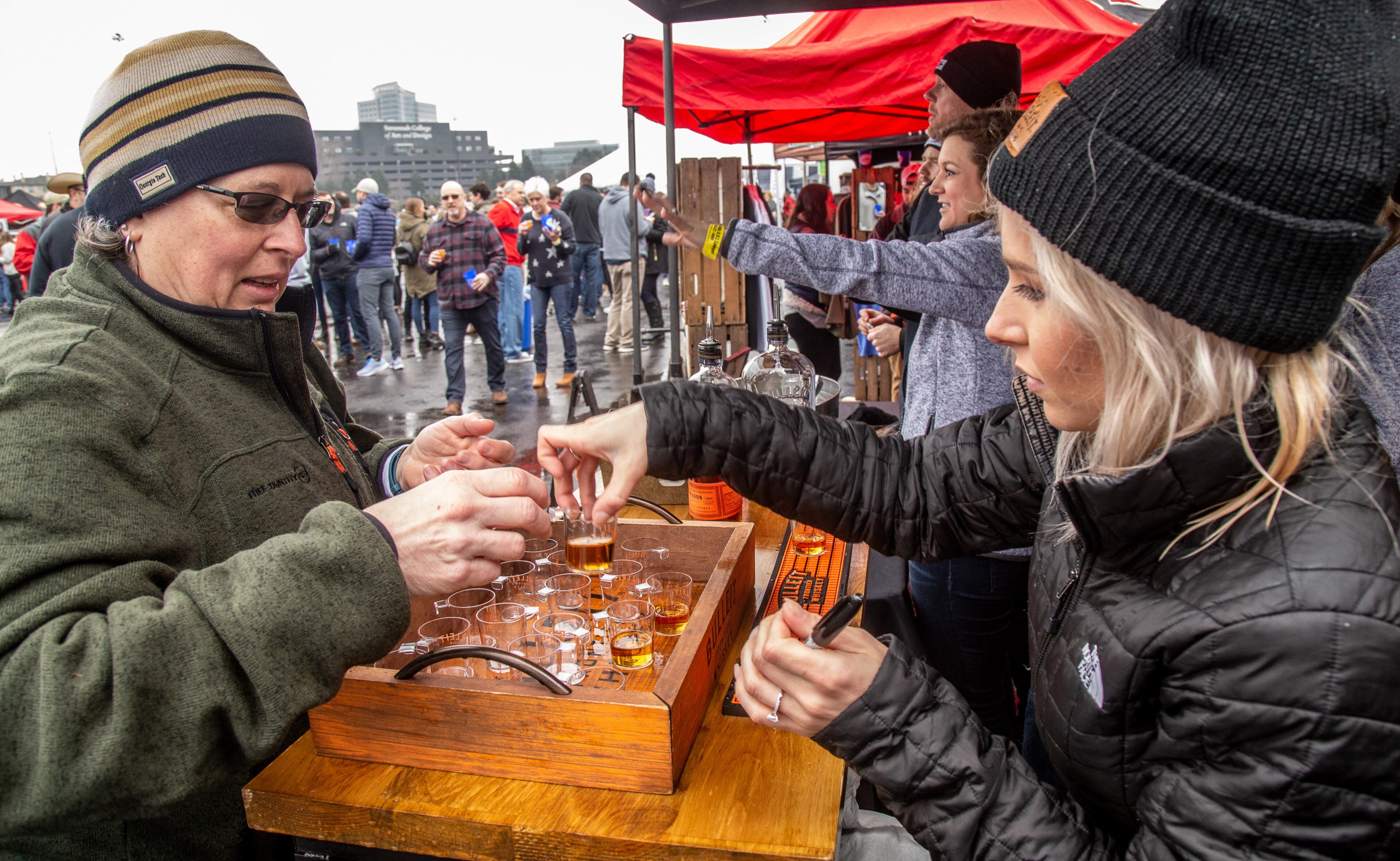 Kim Sanders-Crawford gets her sample of Bulleit whiskey during the Atlanta Winter Beer Festival at Atlantic Station on Saturday, February 1, 2020. STEVE SCHAEFER / SPECIAL TO THE AJC