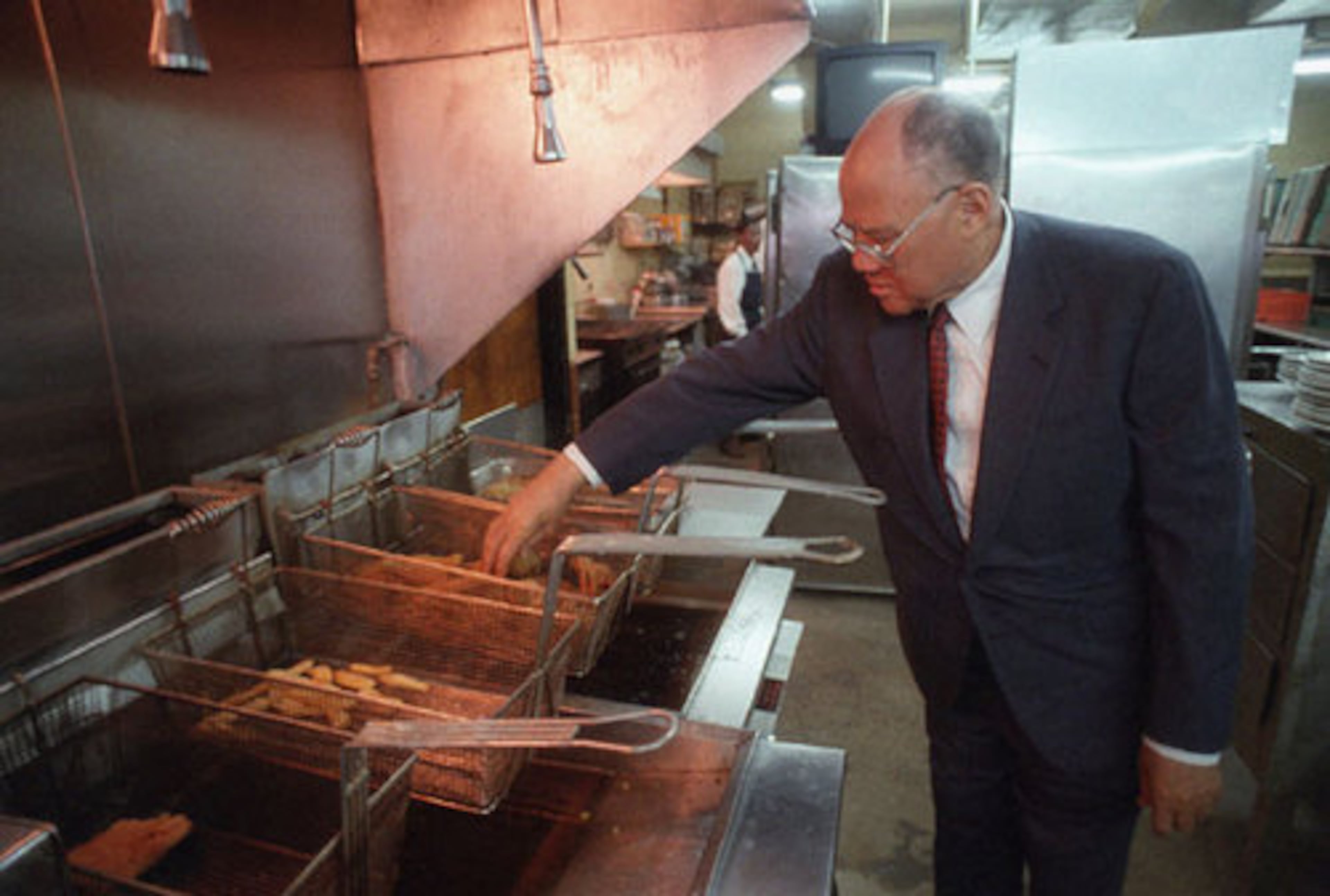 James Paschal checks some fried chicken in the kitchen of his restaurant in 1996. Paschal's was known as the kitchen table of the civil-rights movement.