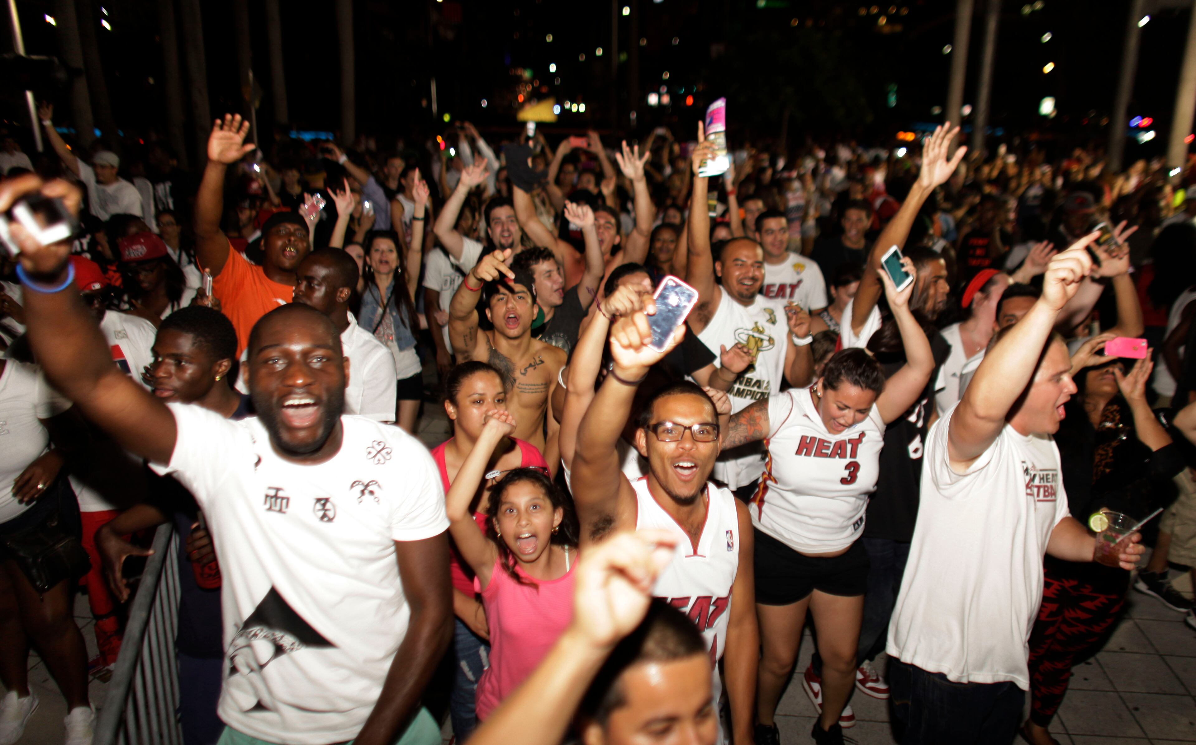 Miami Heat fans celebrate the Championship after the Heat's win against the San Antonio Spurs after the Game 7 of the NBA final basketball series in Miami on Friday, June 21, 2013.. The Heat beat the San Antonio Spurs 88-95. (AP Photo/Javier Galeano)