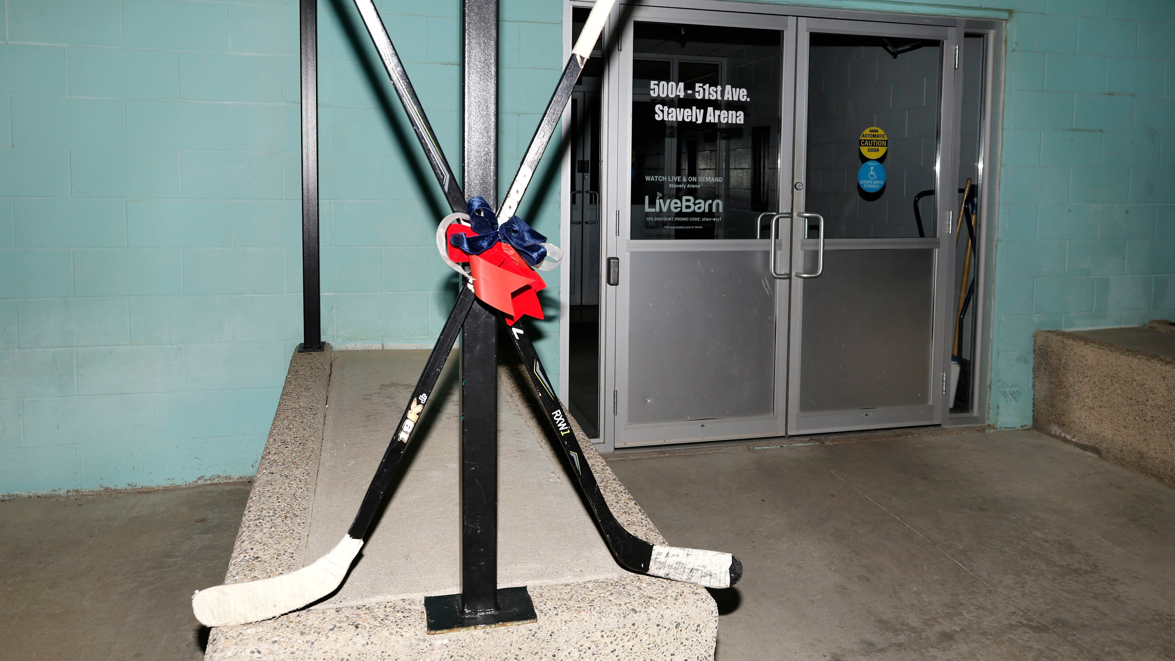 Crossed hockey sticks are shown outside of the Stavely Arena in Stavely, Alberta, Monday, Feb. 2, 2026. (Larry MacDougal/The Canadian Press via AP)