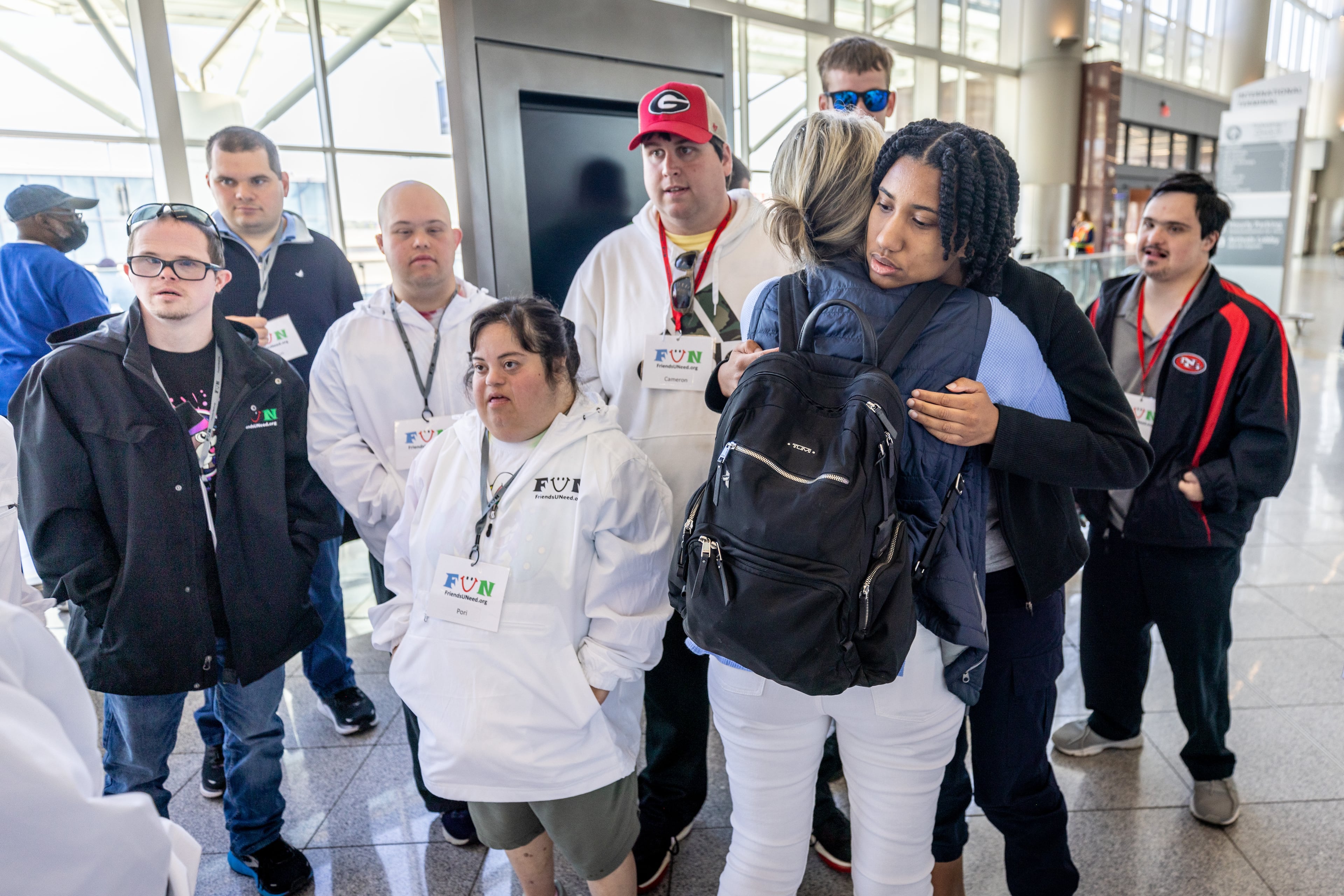Narcy Thiapen, a day program coordinator with FriendsUNeed, helps Gabrielle Johnson calm down before the group enters the security area at the Hartsfield-Jackson Atlanta International Airport during a Wings For All event Tuesday, April 11, 2023. (Steve Schaefer/steve.schaefer@ajc.com)